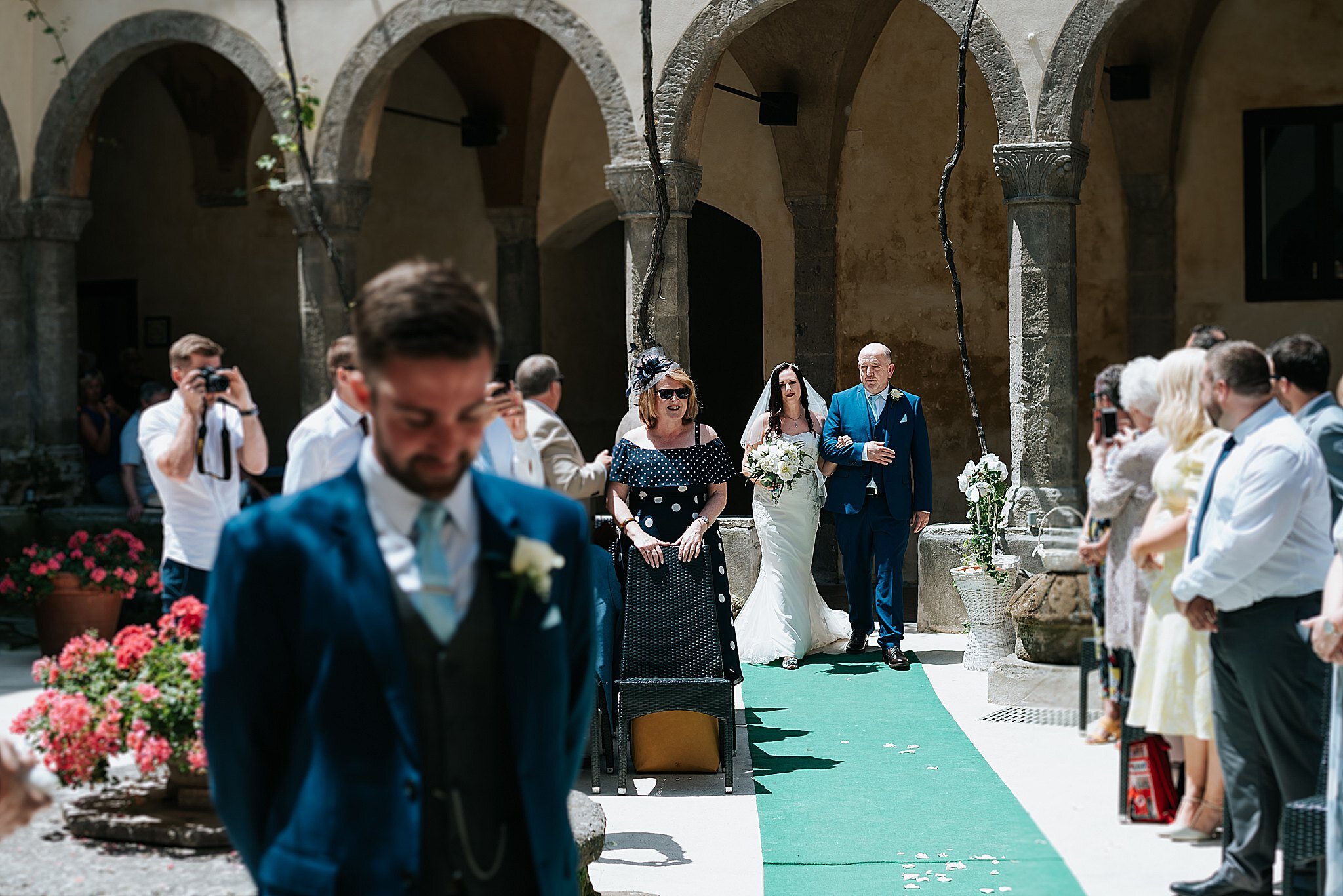 Bride walking down the aisle in the cloisters in sorrento 