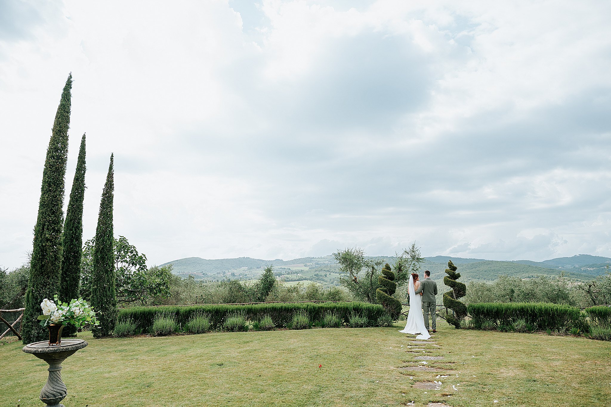 bride and groom in tuscan countryside after wedding 