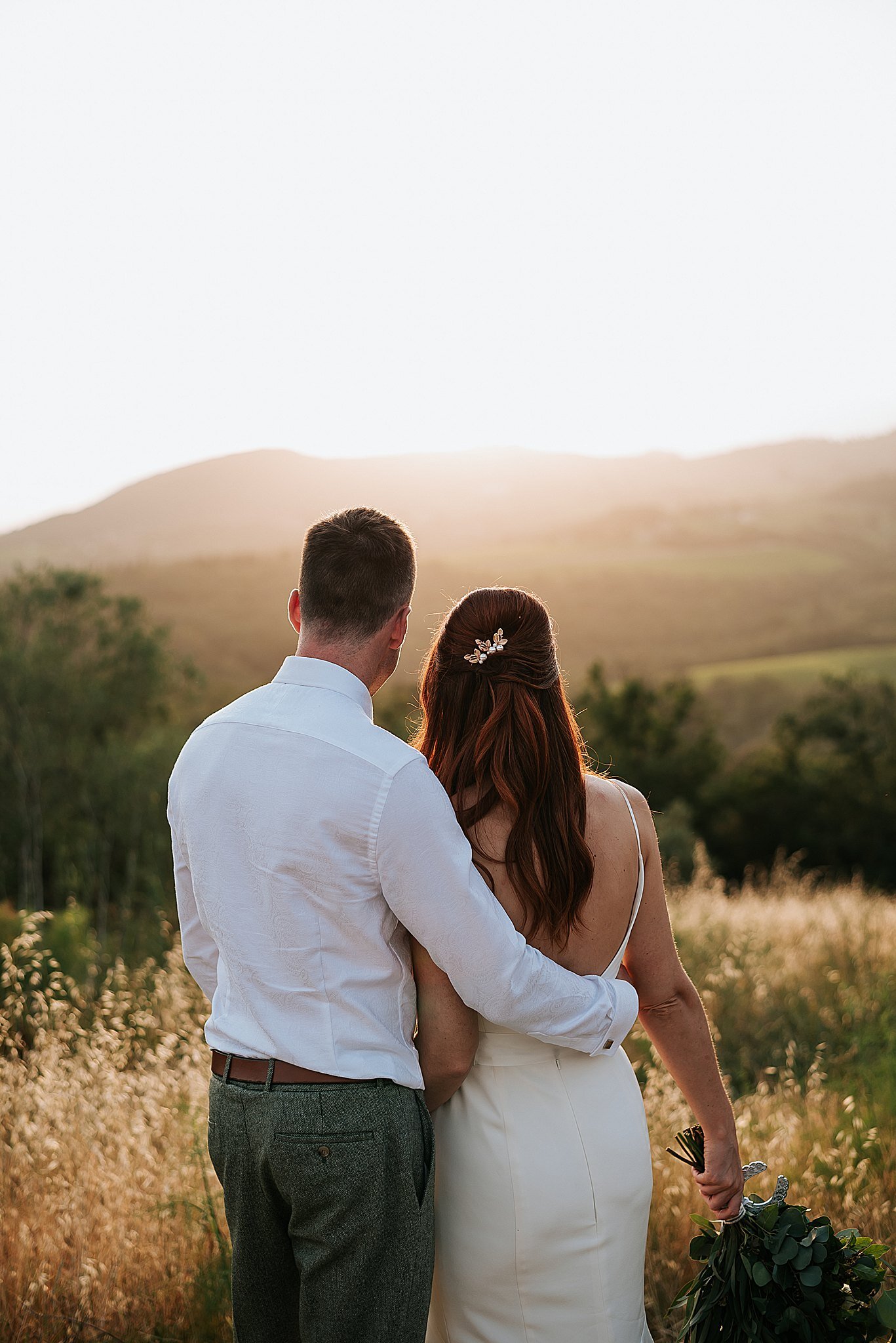 bride and groom enjoying sunset in tuscany