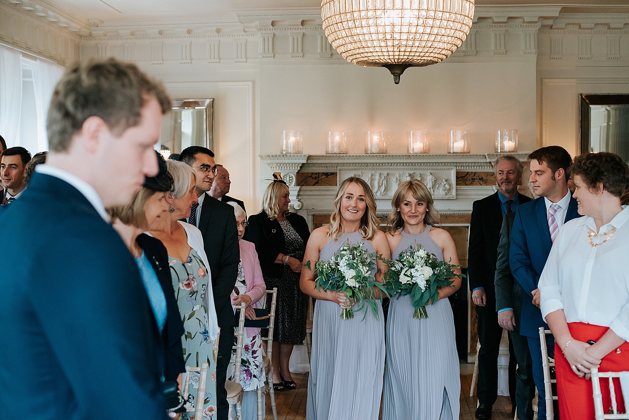 brides maids walk down the aisle at eaves hall 