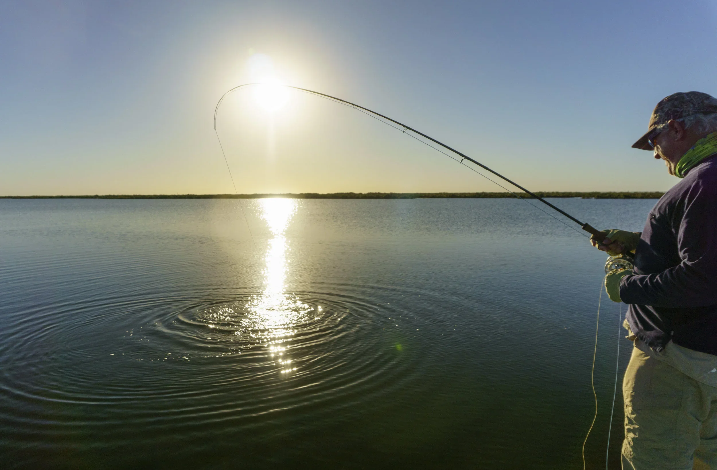 Angler sight casting from a skiff on the Texas coast