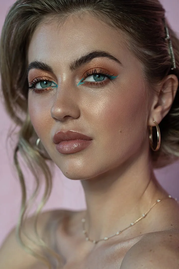 Woman with beautiful makeup on pink background photographed by Philadelphia Photographer Justus Henry