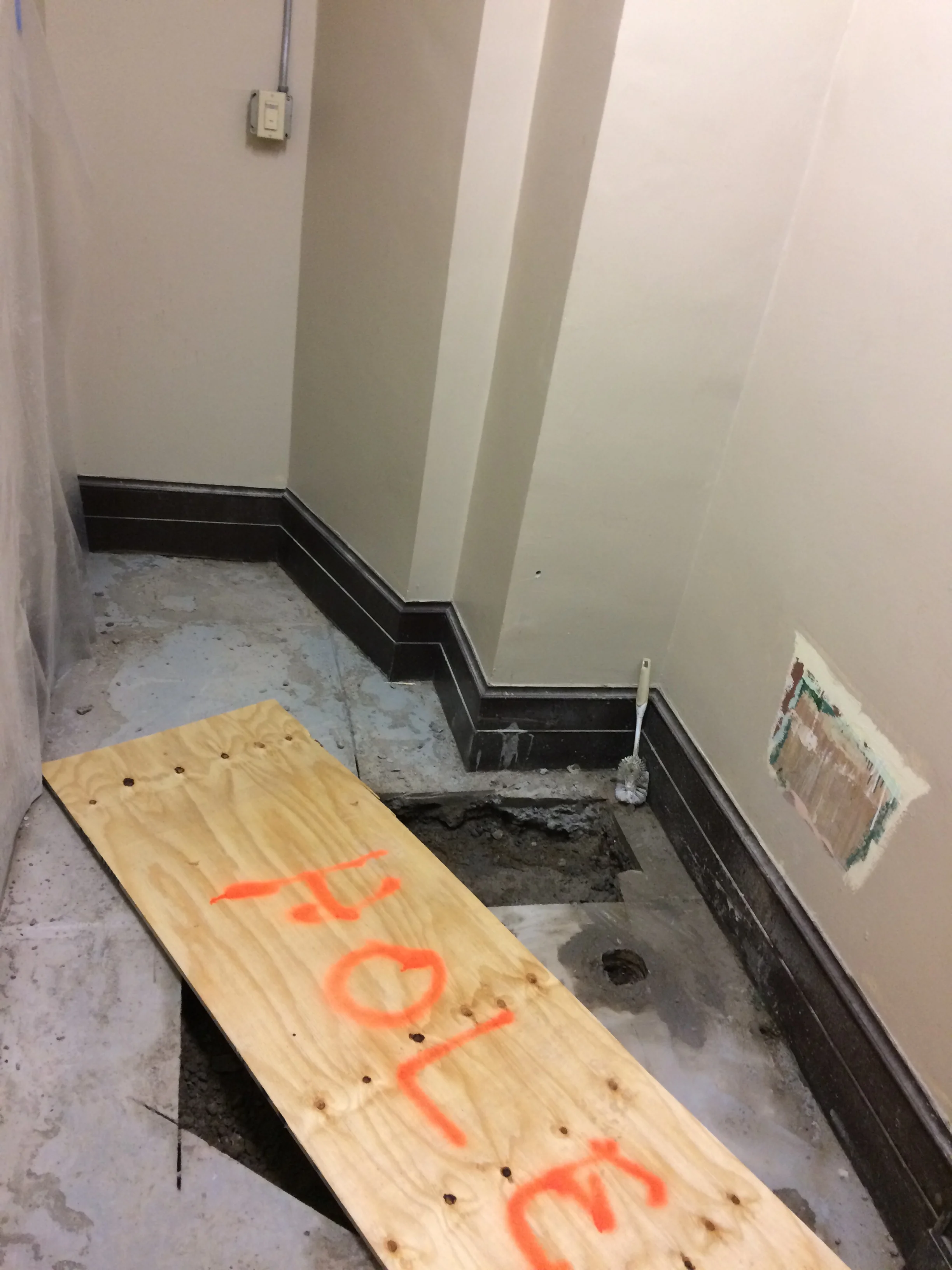 Removal of fixtures in old public restroom and trenching for new sanitation lines