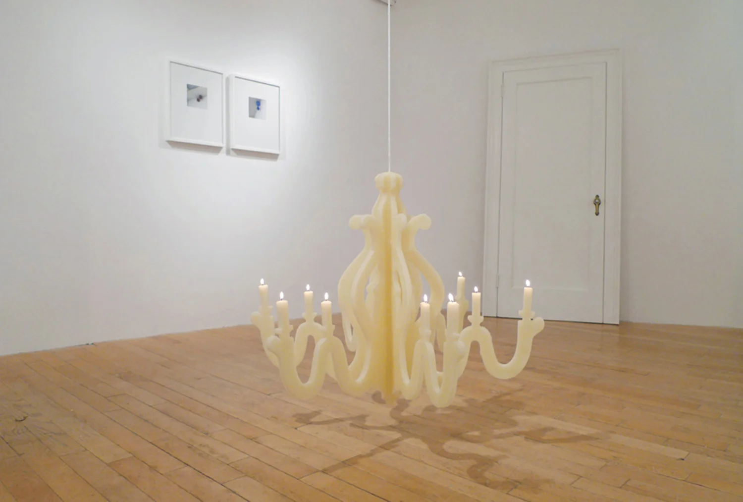 Memory is a Hussy . Beeswax, wicks, weights, and rope. Installation view at Illuminated Metropolis gallery in New York City. 2011.