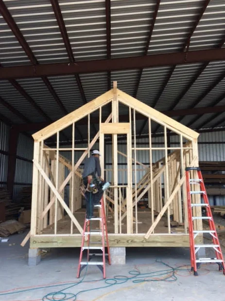 The pitched gable roof is up.