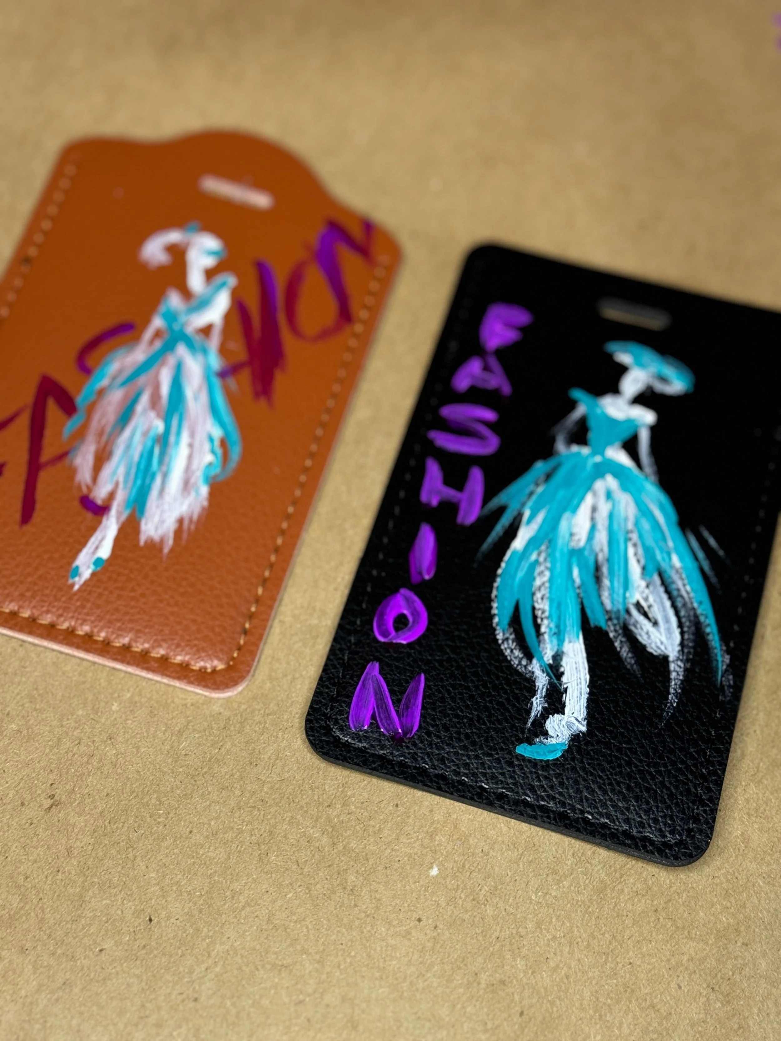 Custom hand-painted fashion illustrations on leather luggage tags — brand activation illustration by Danielle Rose Fisher NYC