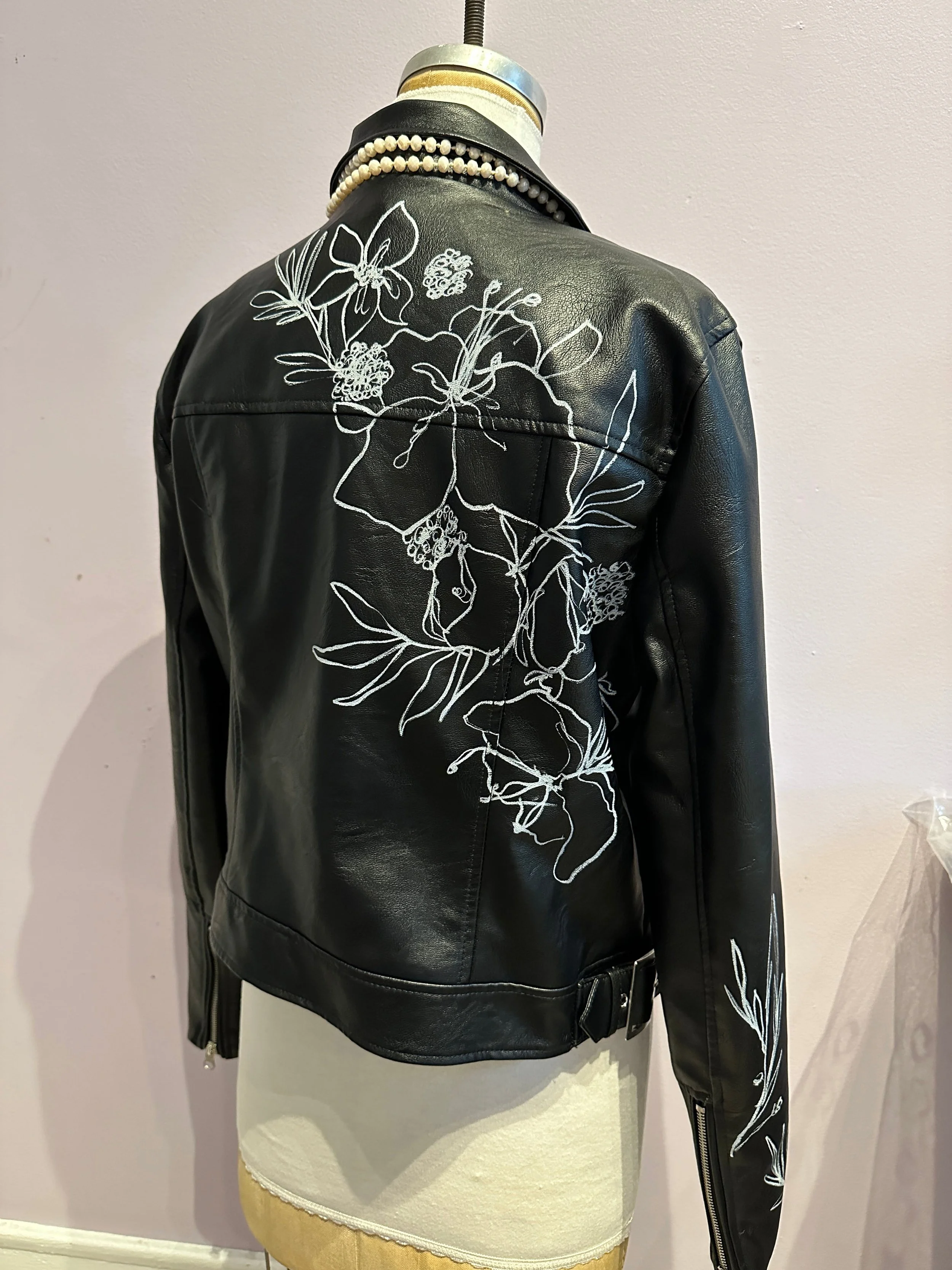 Custom illustrated leather jacket featuring detailed hand-painted artwork.