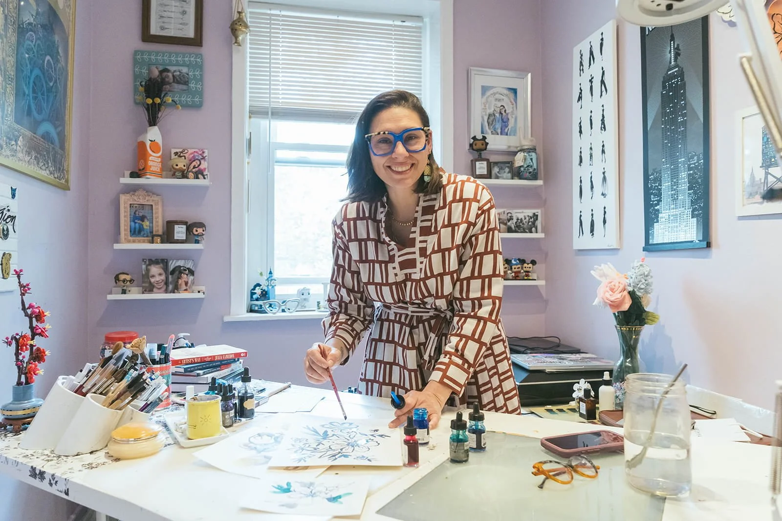 Danielle Rose Fisher painting watercolor illustrations live at an outdoor art show — NYC brand activation illustrator