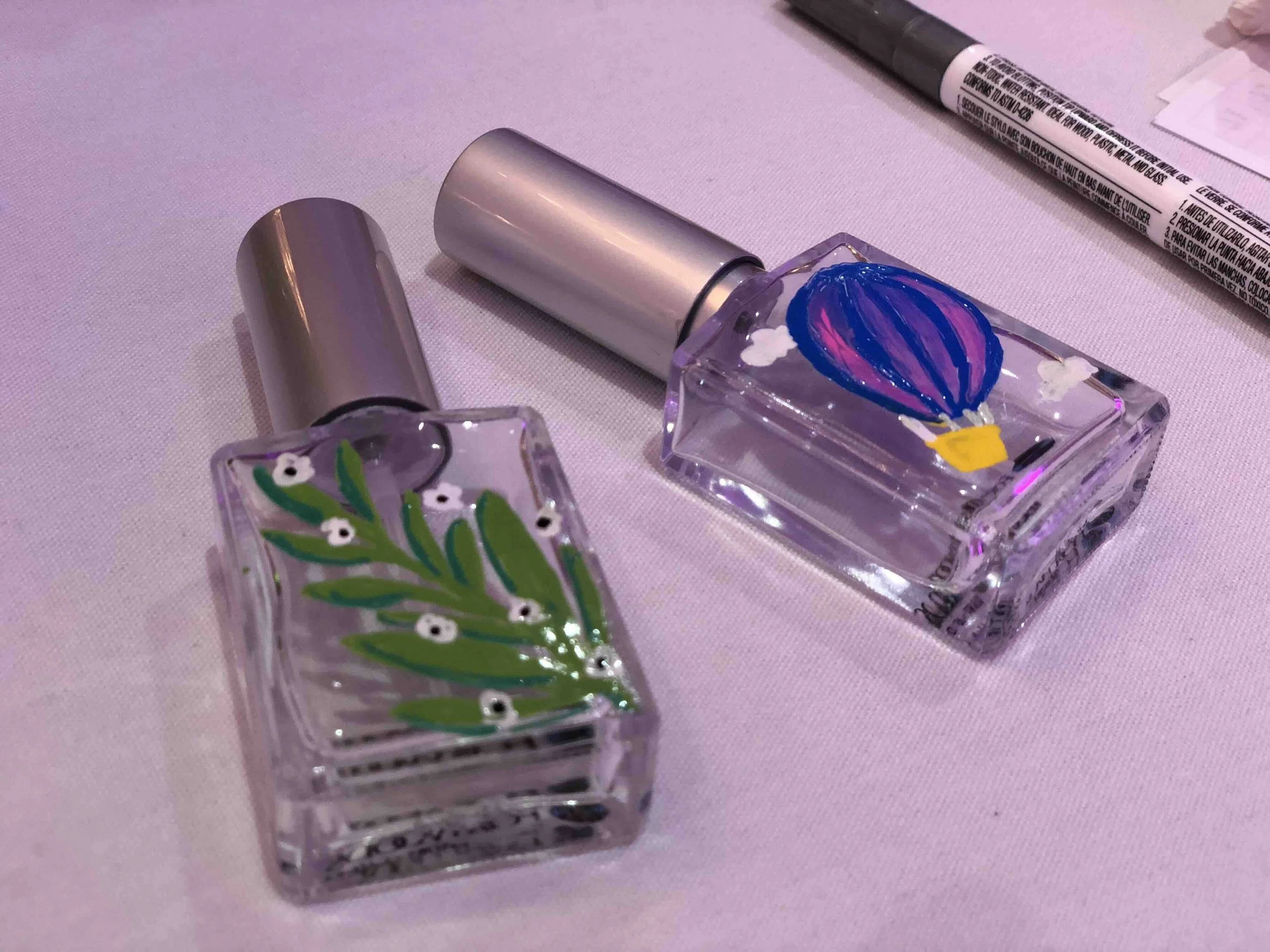 Live perfume bottle illustration at a brand activation event — hand-painted bespoke keepsakes by Danielle Rose Fisher NYC