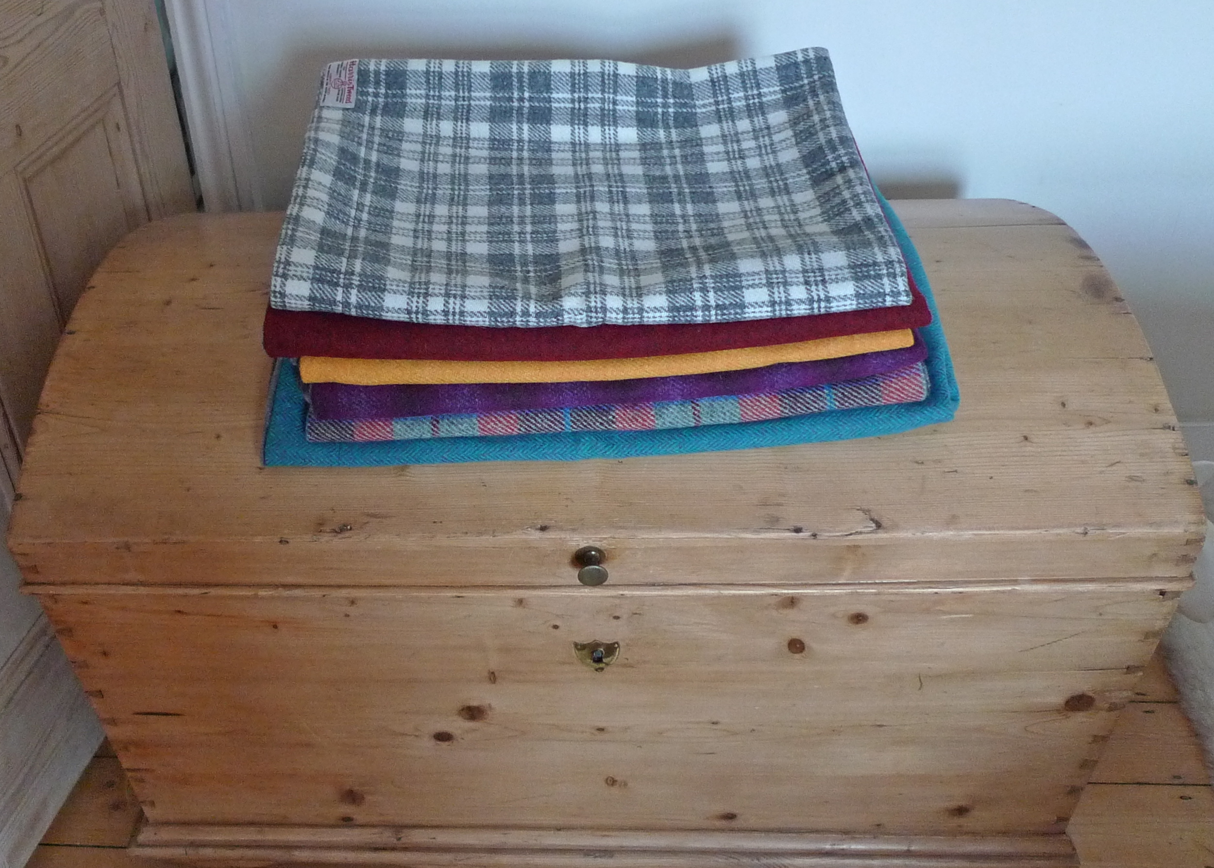 Grey and white check, red and black, yellow, turquoise red and brown check, turquoise herringbone Harris Tweed throws