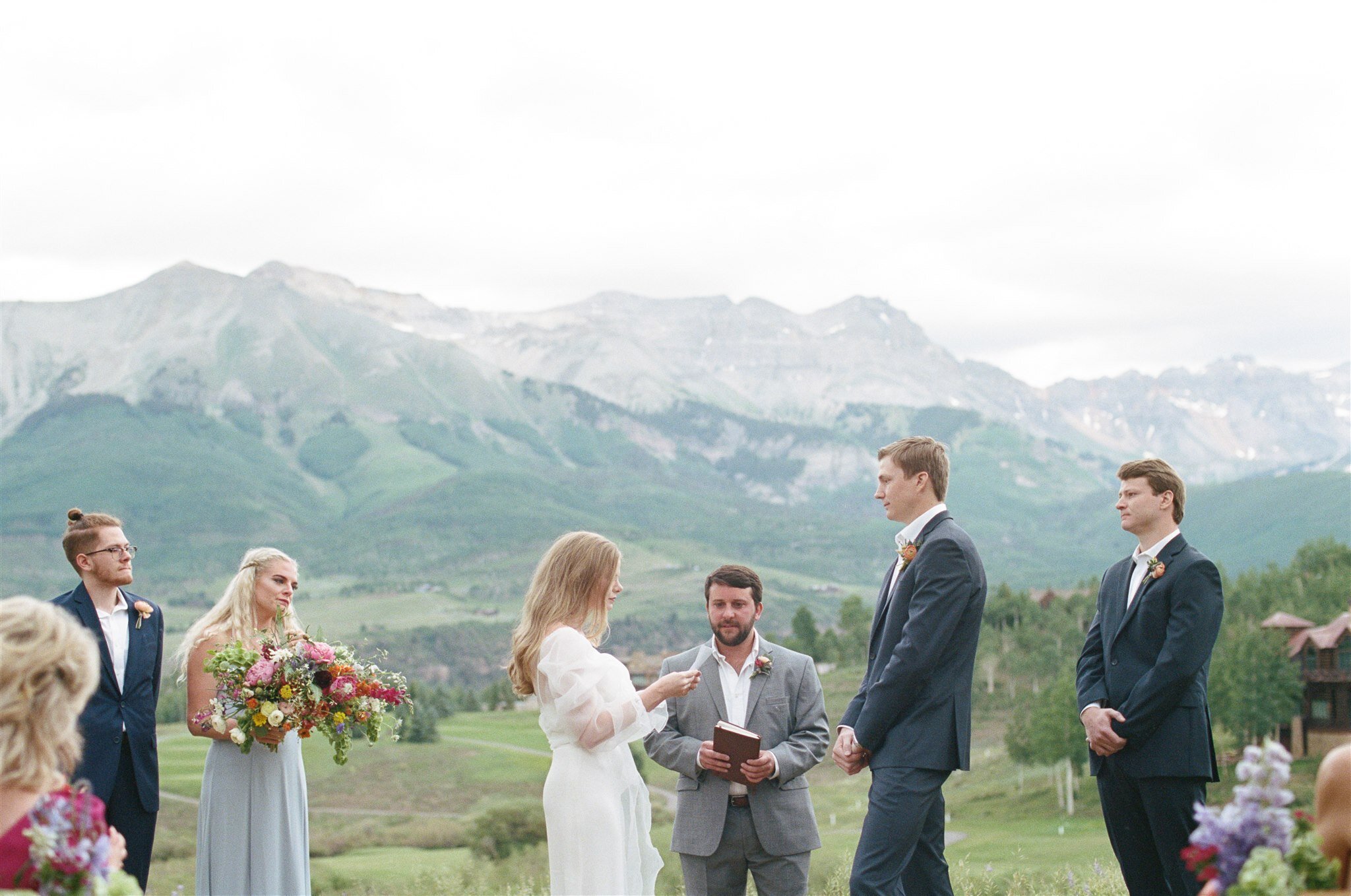  a bride and groom exchanging vows during their outdoor wedding in the mountains in Telluride, Colorado 