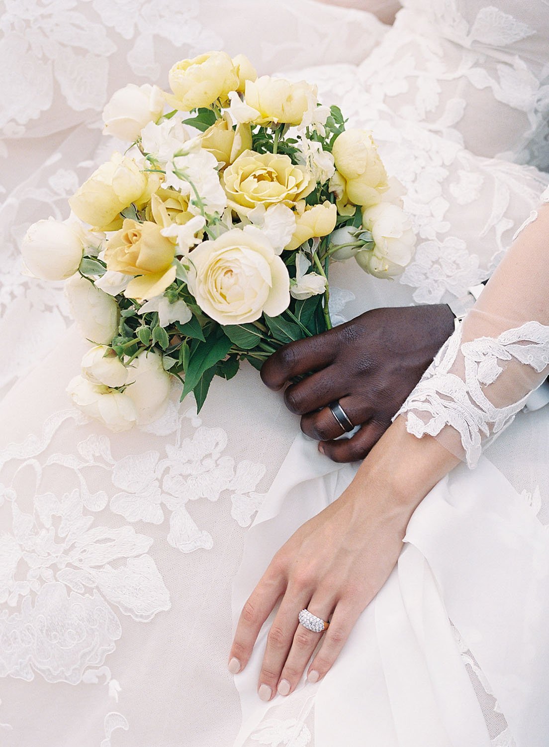  a gorgeous bridal bouquet of pale yellow and white on the lovely lace skirt of the 'Maeve' by Monique Lhuillier wedding dress 