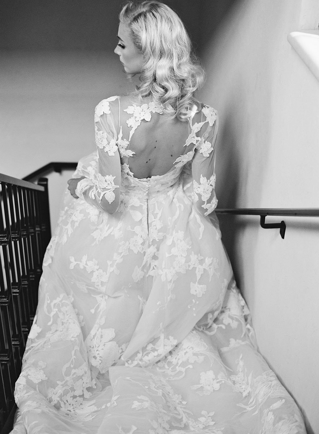  The gorgeous open back of the 'Maeve' by Monique Lhuillier wedding dress with sheer illusion lace sleeves and a lovely full skirt. 