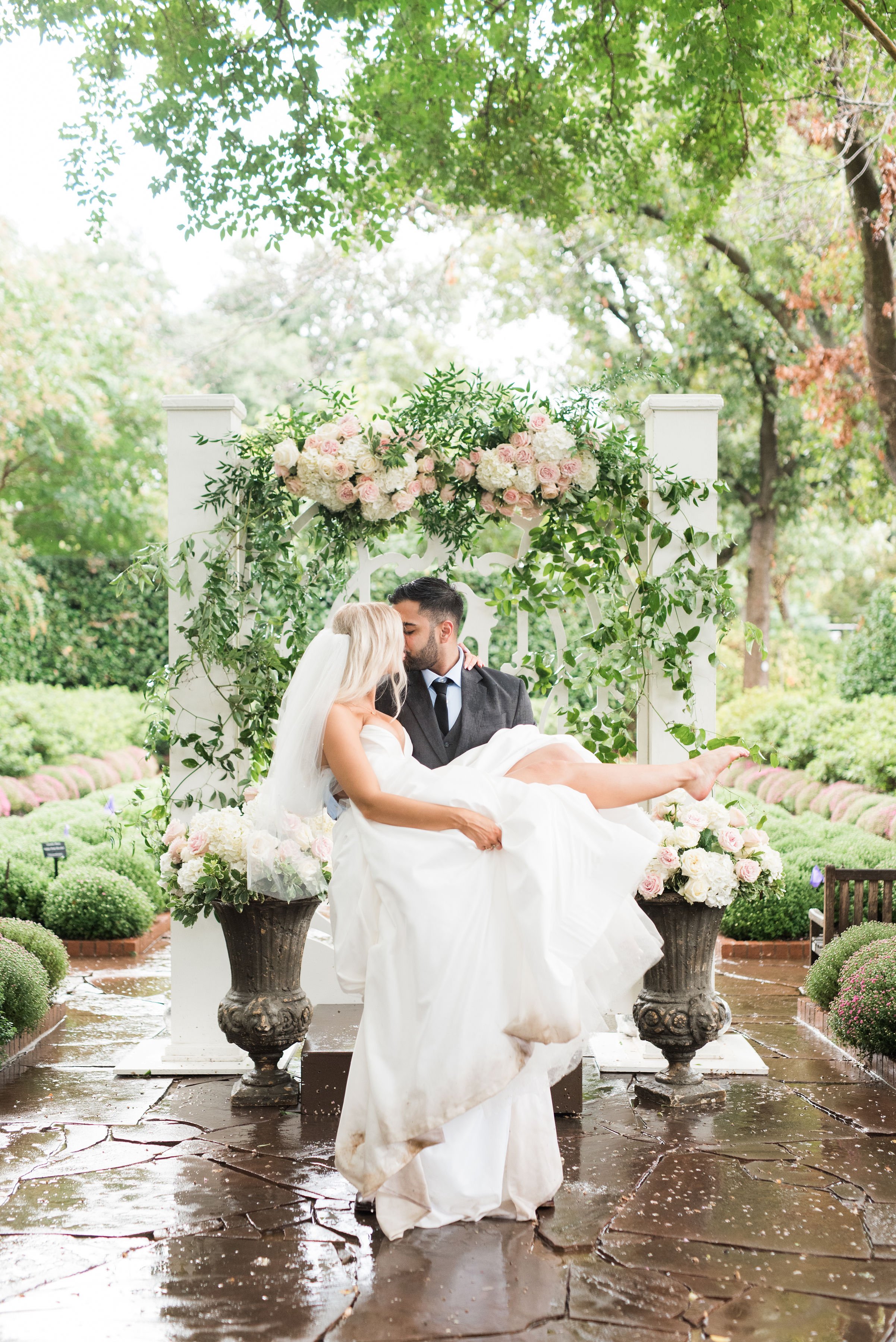 a romantic garden rainy wedding featuring an ines di santo ball gown