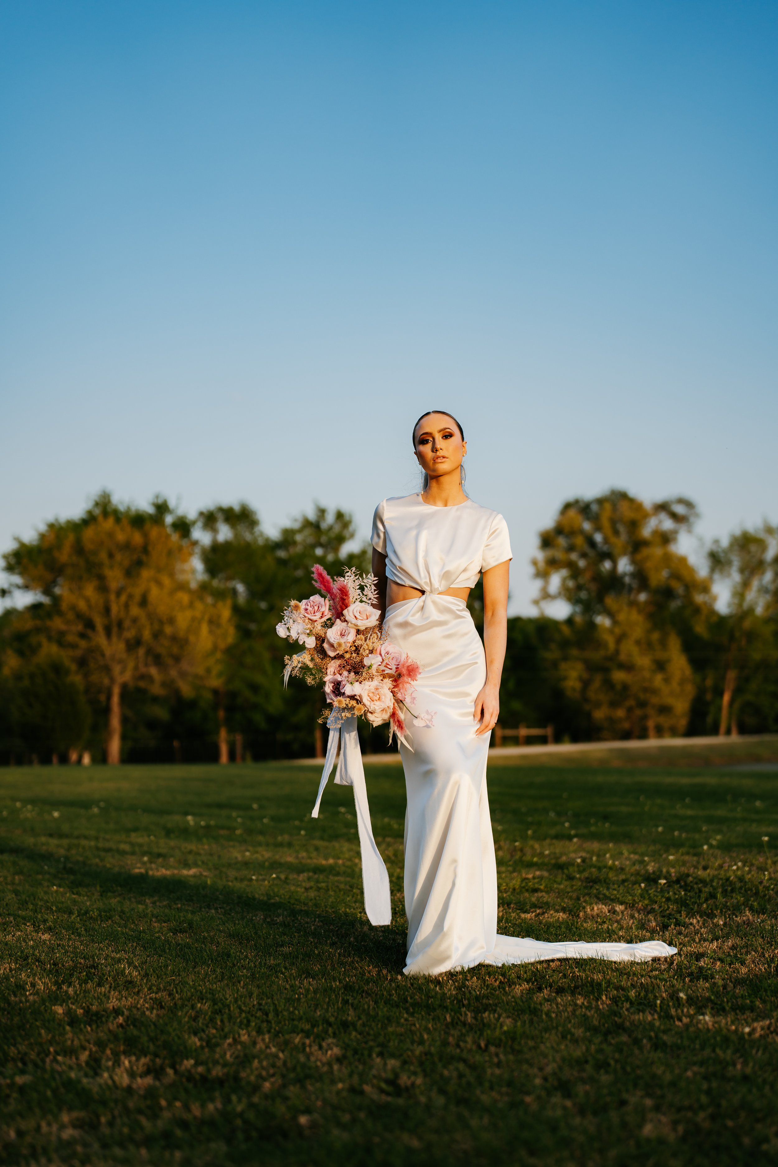 modern silk wedding dress with twist front and tee shirt sleeve details by the label by aandbe and anna be bridal shops