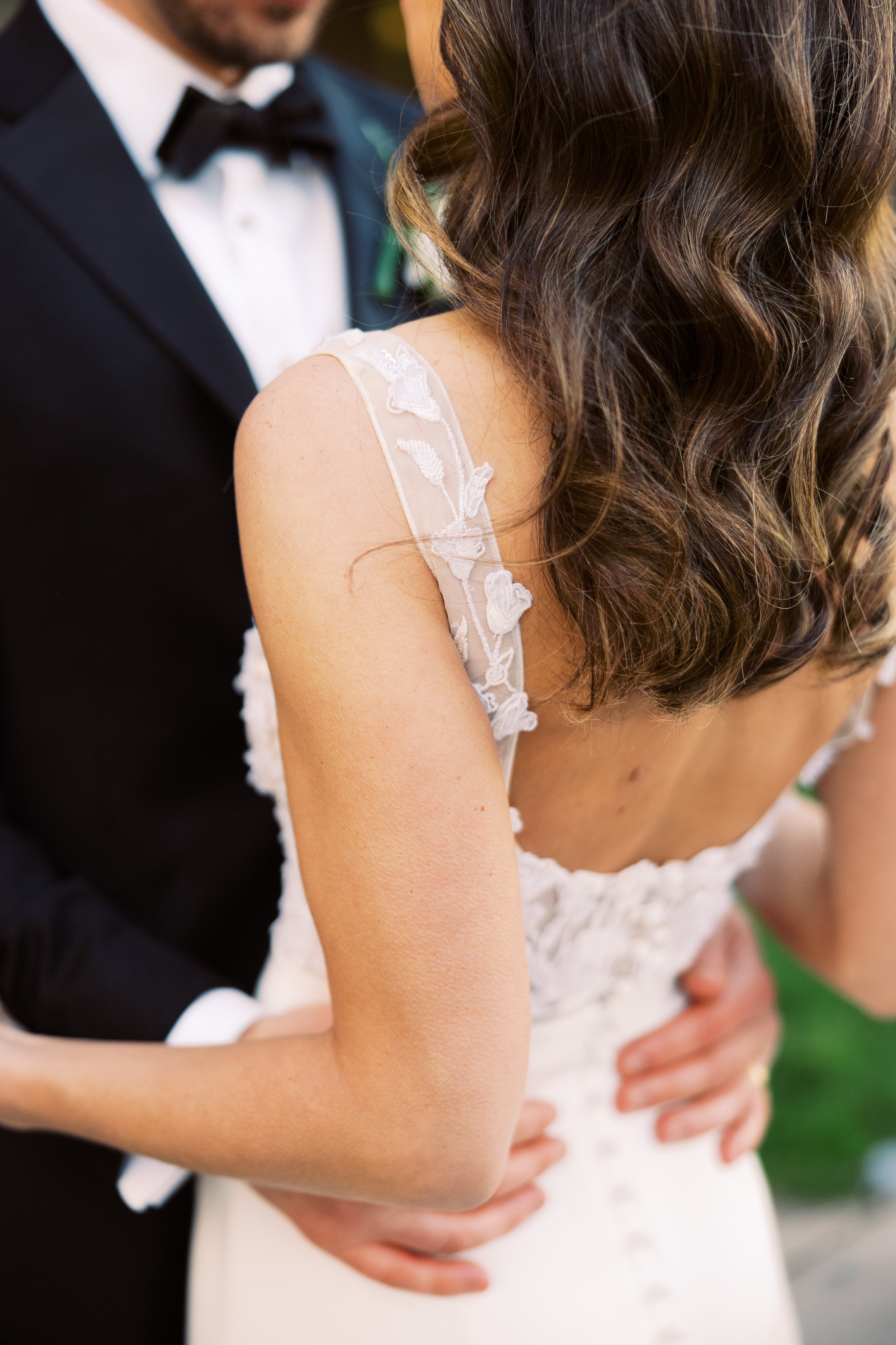 a textured 3D applique wedding dress from alexandra grecco with a crepe skirt.