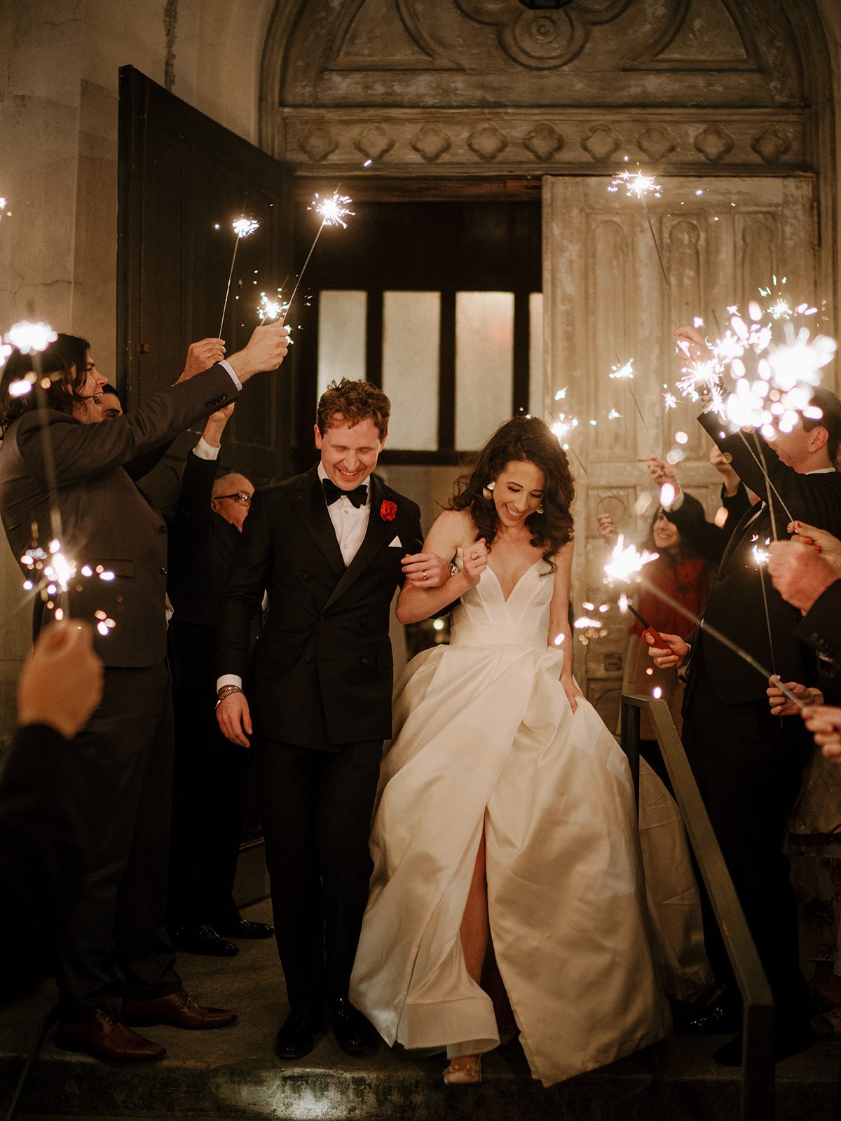 wedding reception exit with sparklers in new orleans with a classic and cool ball gown by ines di santo.
