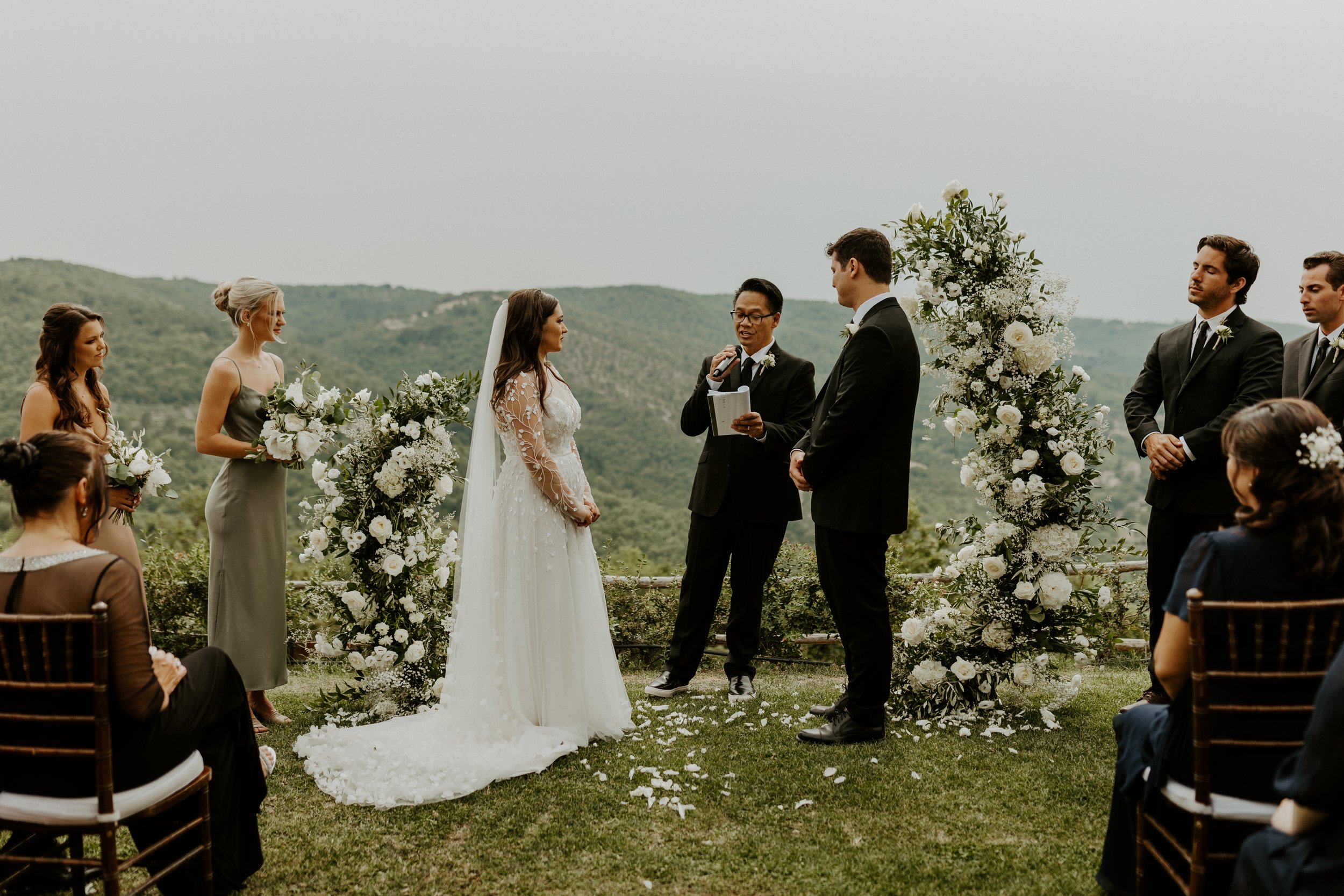 dreamy destination wedding in tuscany featuring a dramatic floral arch and ines di santo wedding dress from anna be