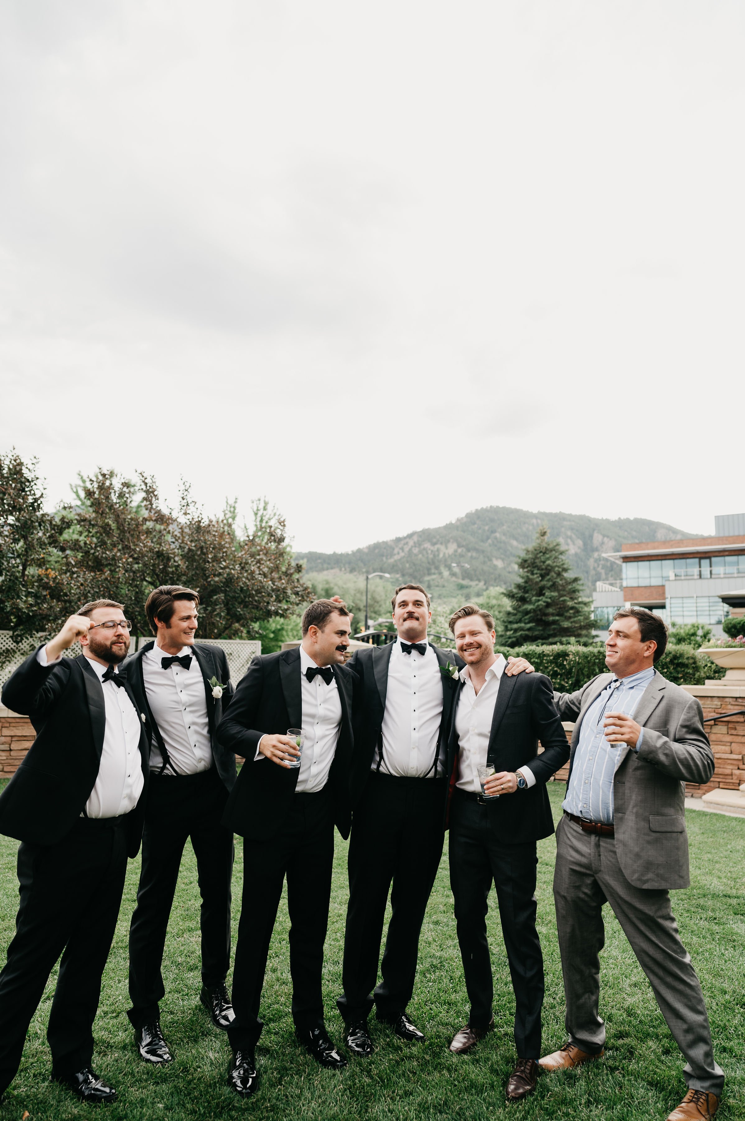 classic suits for the best men in this outdoor mountaintop wedding