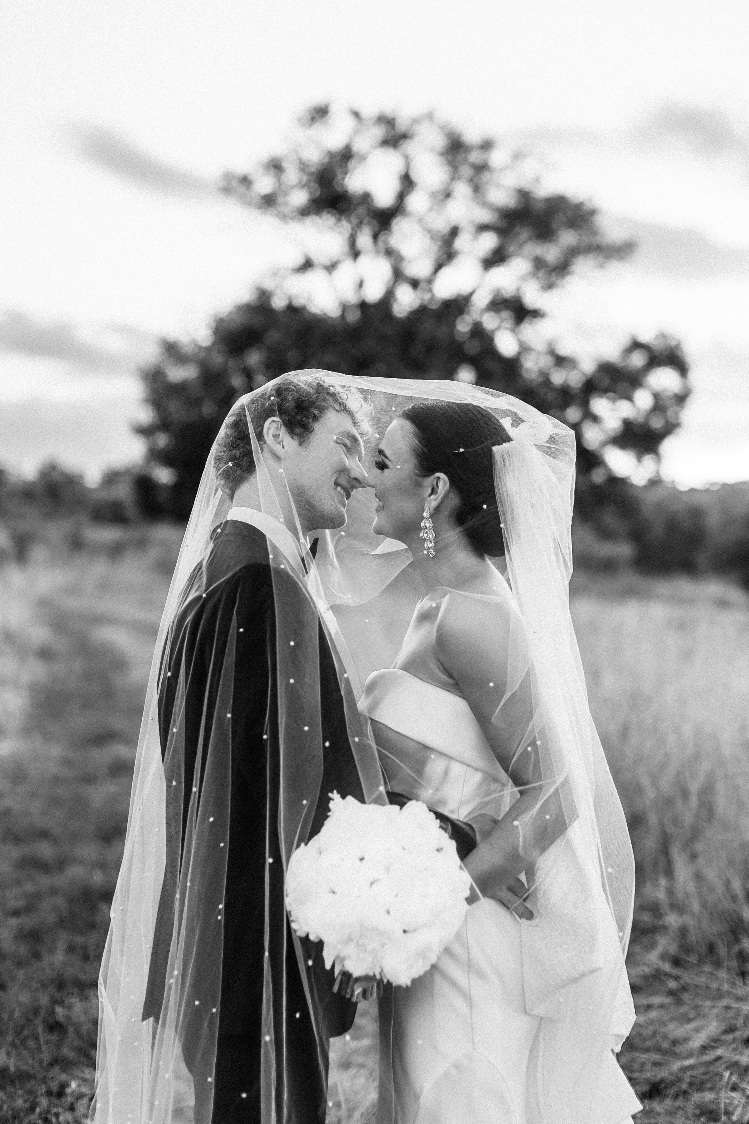 modern and timeless bridal portraits taken in a sunset field