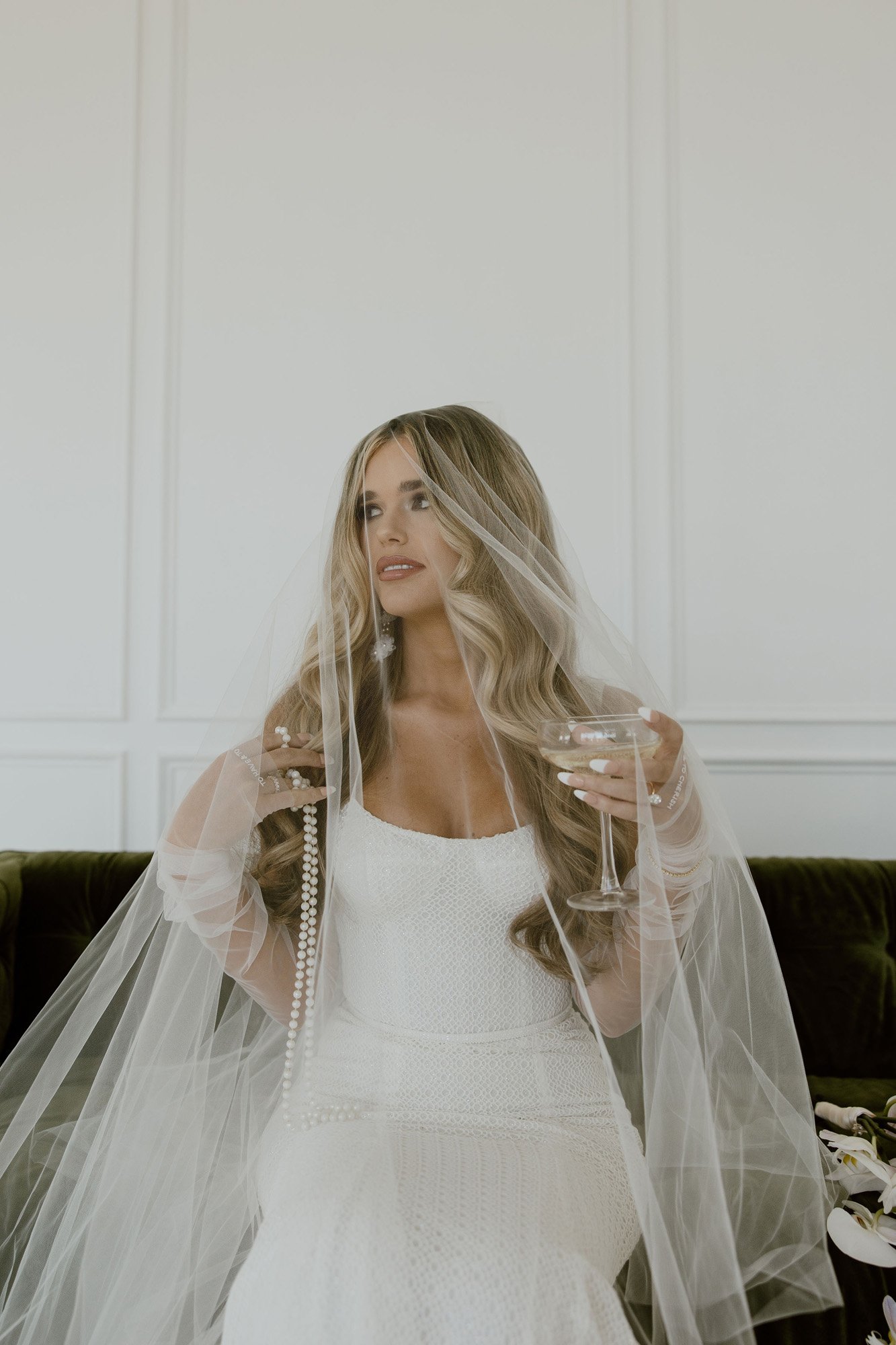 a cool modern bride wearing a veil and pearl sheer gloves in this texas wedding.