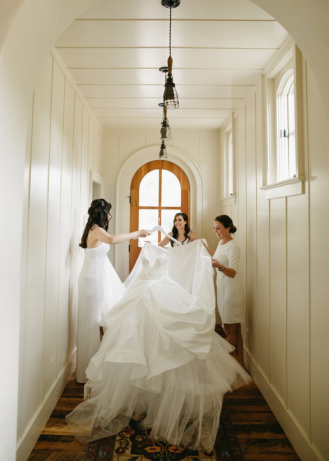 a bride getting ready at the surf hotel in colorado featuring the quice dress by ines di santo