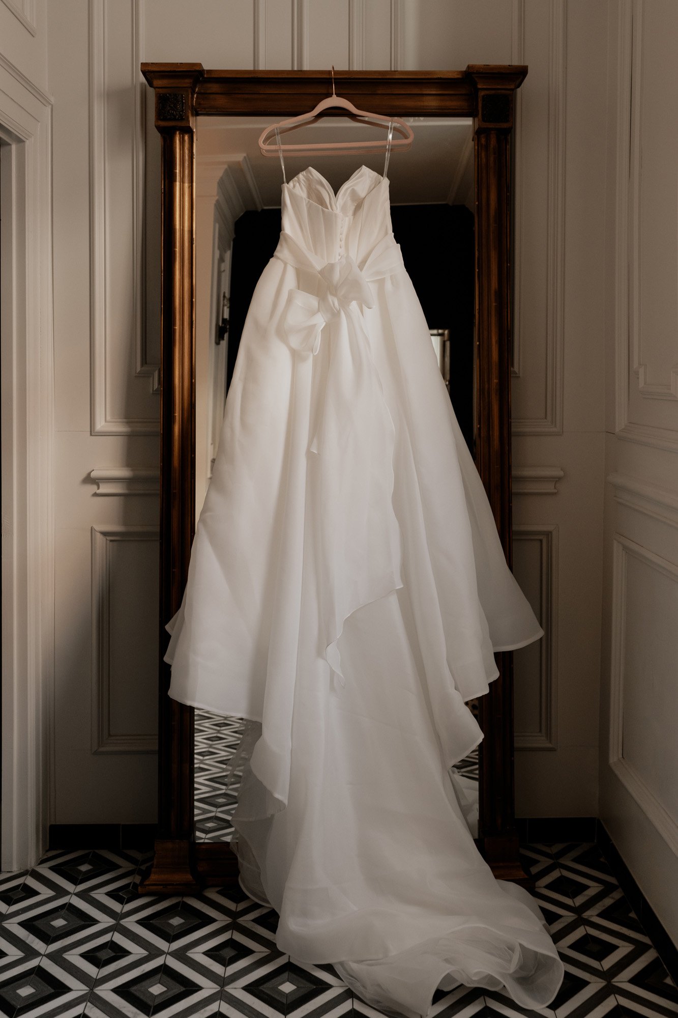 the eva lendel samanta ball gown hanging at the mason in this classic and timeless dallas wedding