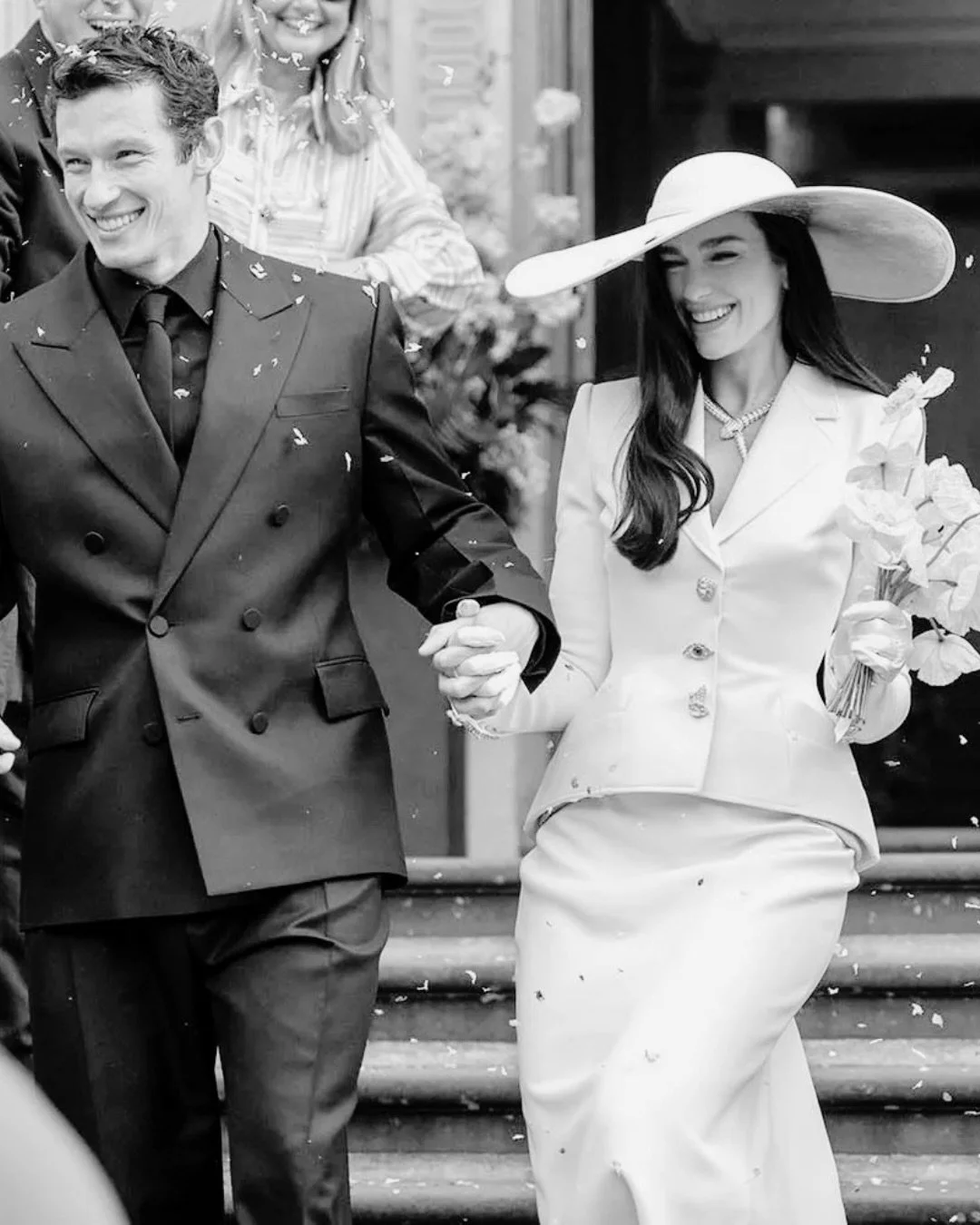 this just in: @dualipa got married in a custom @schiaparelli skirt suit, with a wide brim hat, gloves, + of course @christianlouboutins. talk about iconic. congratulations to the beautiful couple 🖤

what do you think of her wedding look?

#dualipa #