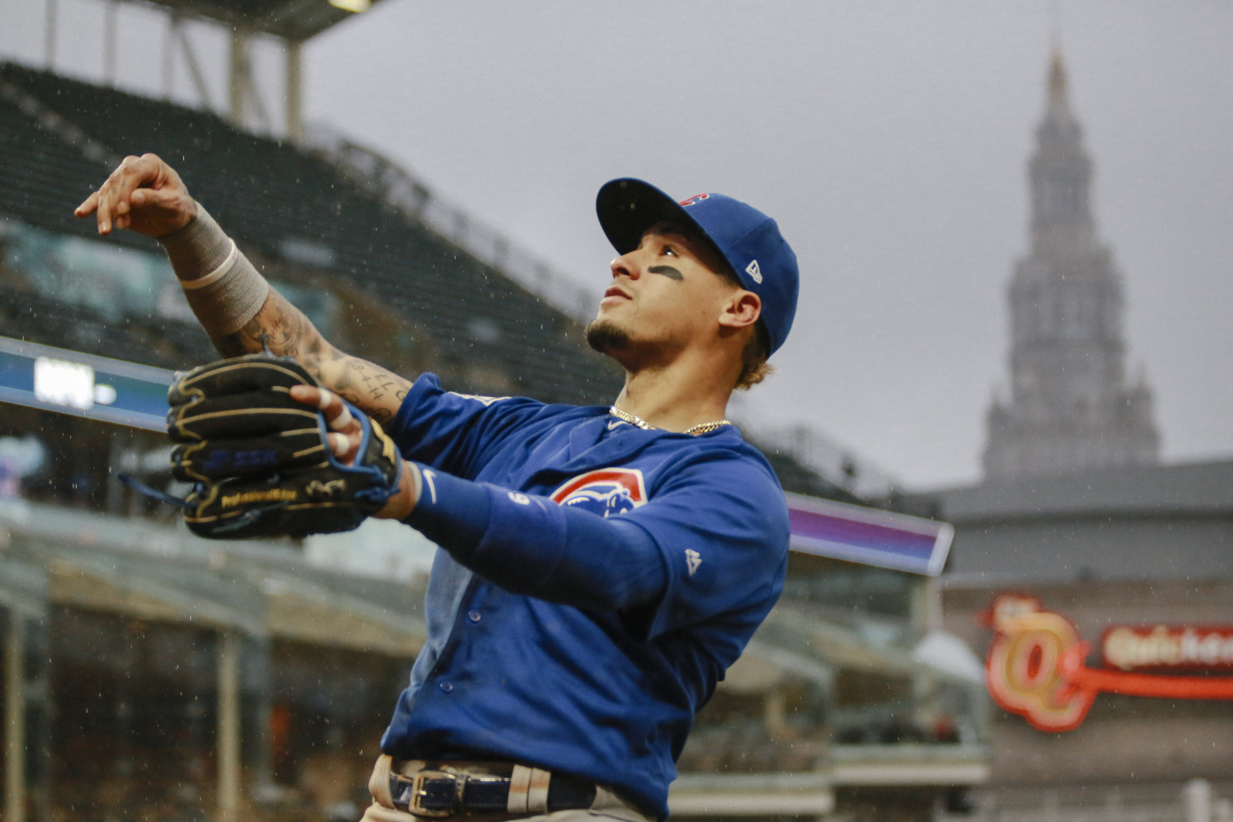 Javier Baez throws a ball into the crowd at the conclusion of the inning during the first matchup between the Cubs and Indians since the 2016 World Series.