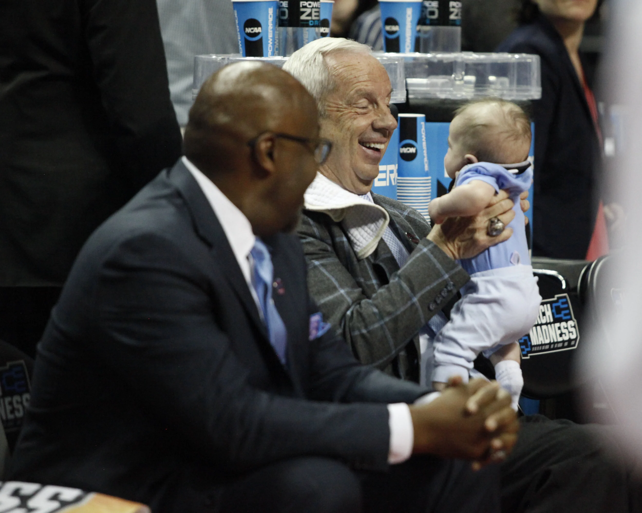 Coach Roy Williams smiles at his grandson Kayson Newlin before the game against Texas A&M.