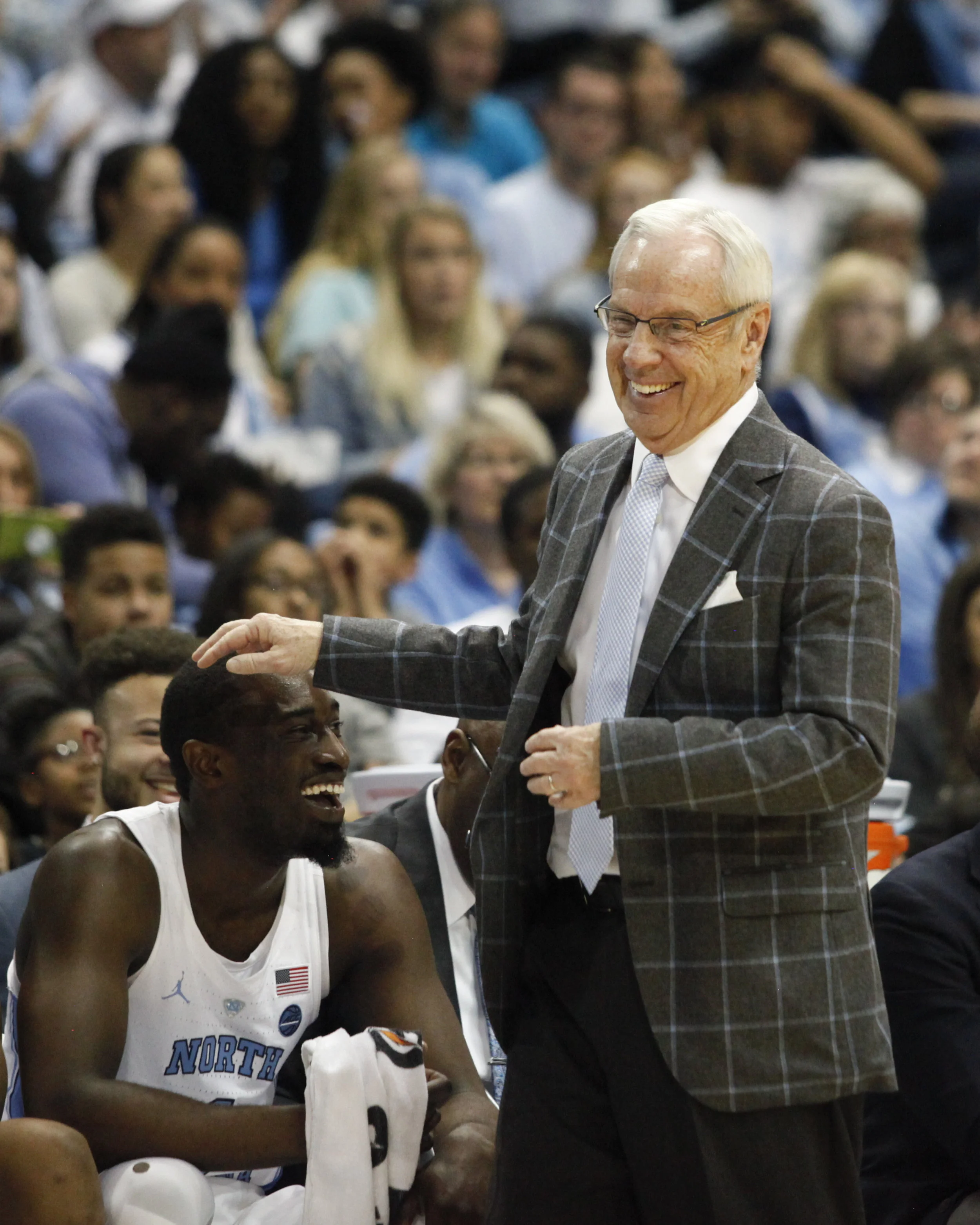 UNC head coach Roy Williams pats senior Theo Pinson on the head during a game at the Dean Smith Center.