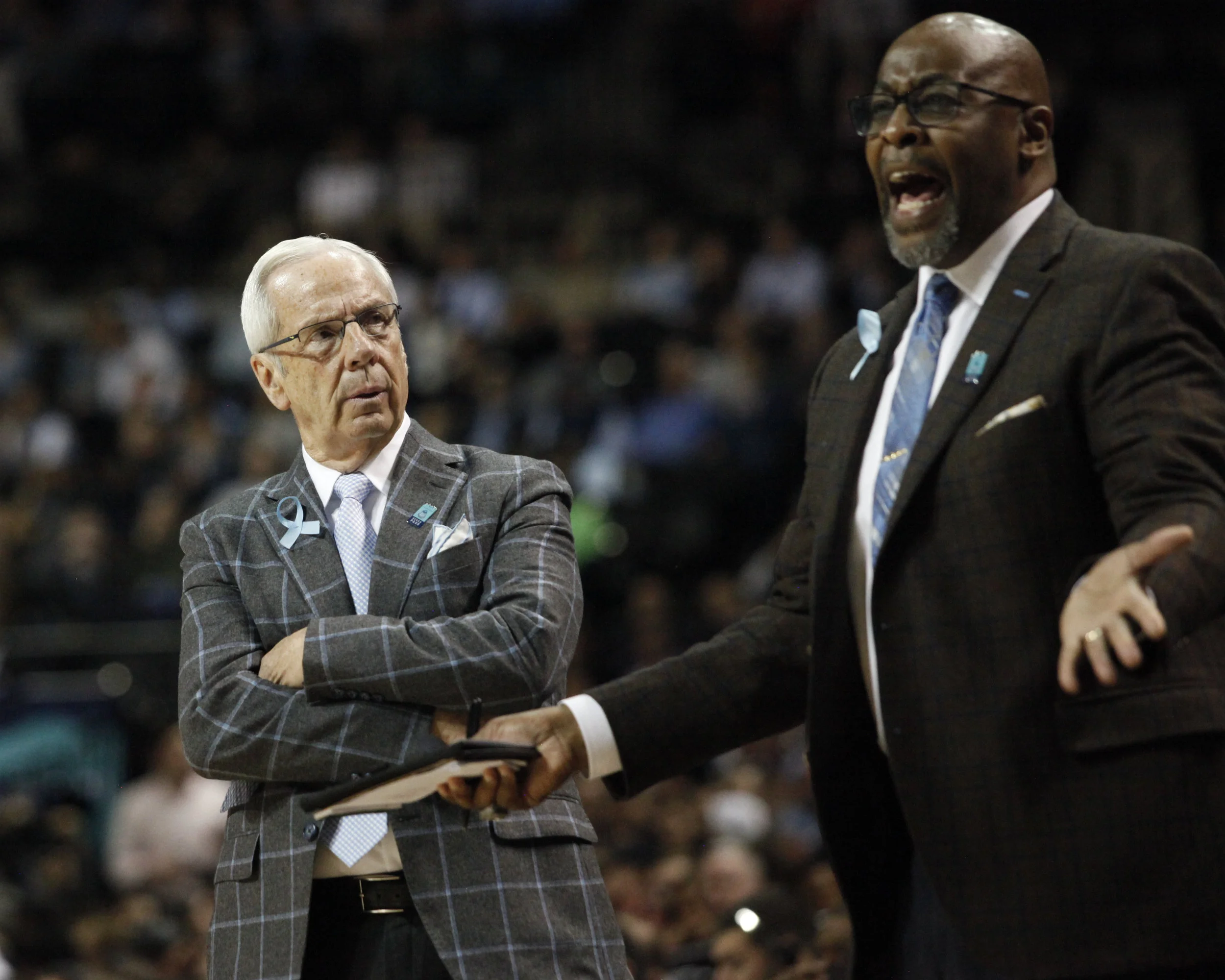 UNC head coach Roy Williams looks at assistant coach Steve Robinson during the ACC Tournament.