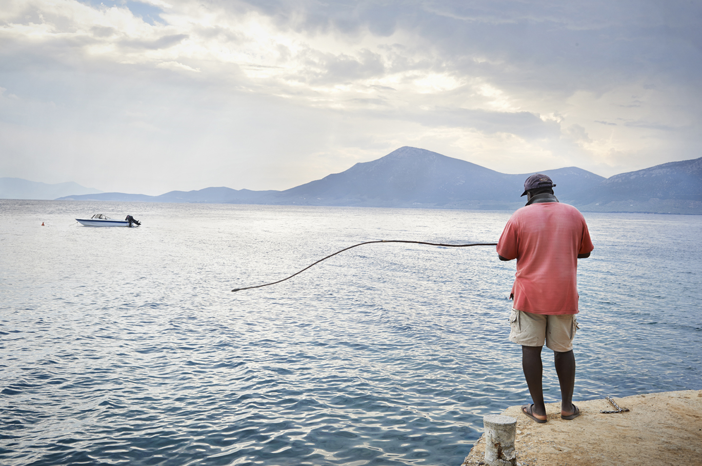 Ernest the island's caretaker fishing with a homemade rod.