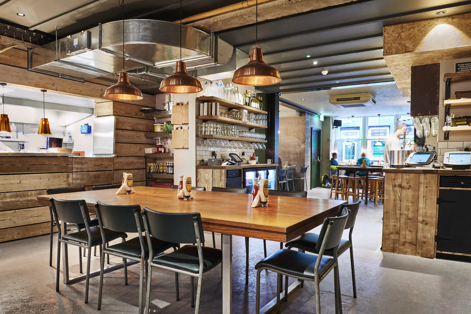 The main table in Honest Burger's new location in Liverpool Street. Imagery and Photography by London based still life and food photographer Scott Grummett