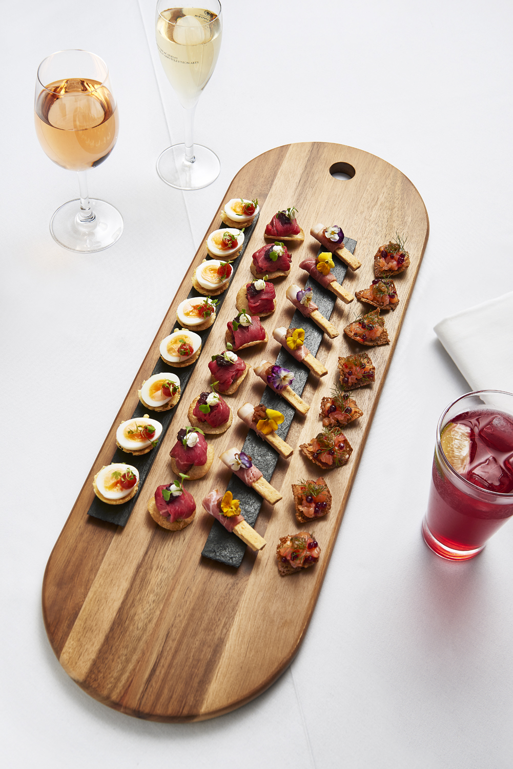 Food photographer by London food photographer Scott Grummett. Shooting for Bafta. Images of Canapés on sharing platters with drinks. Beef, eggs, ham and Salmon