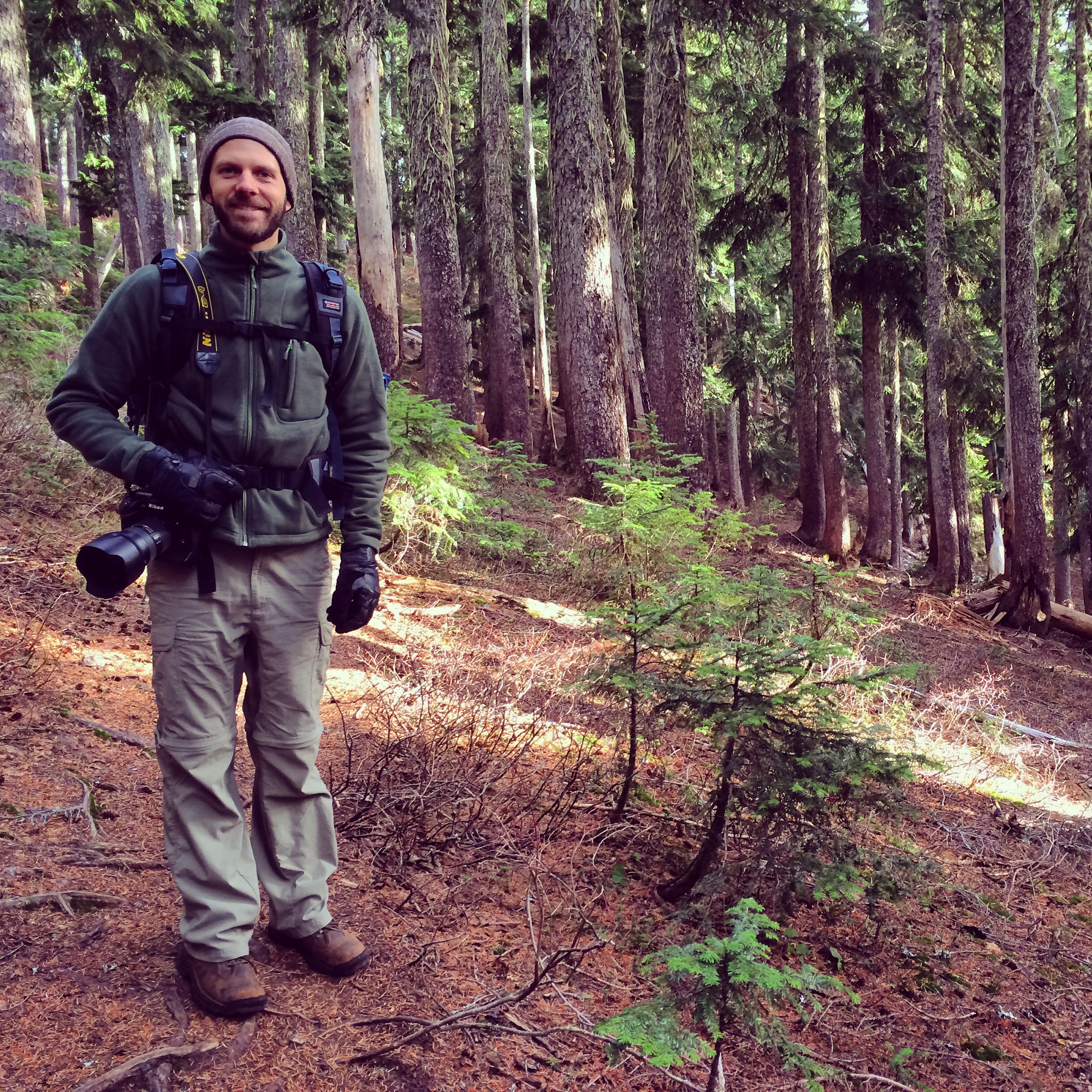 Christopher posing for a picture in the woods. Got his camera ready to capture some of the beautiful surroundings.