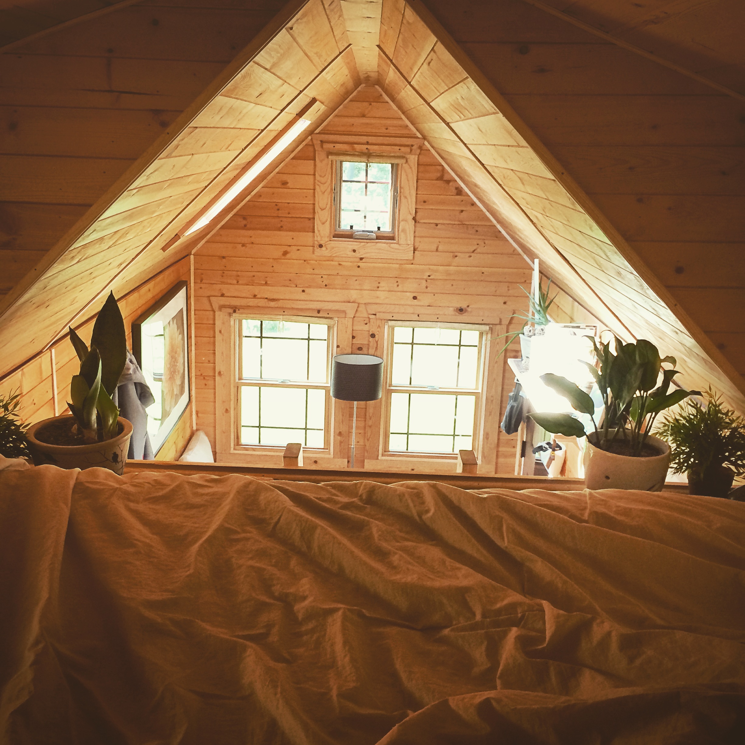 I will never get over how cozy my loft is! Even if it's 90 degrees up there... I will still take a nap! I'v considered painting my walls white at one point, but I'm happy with they way they are right now. The warm glow just punches the cozy up another level!
