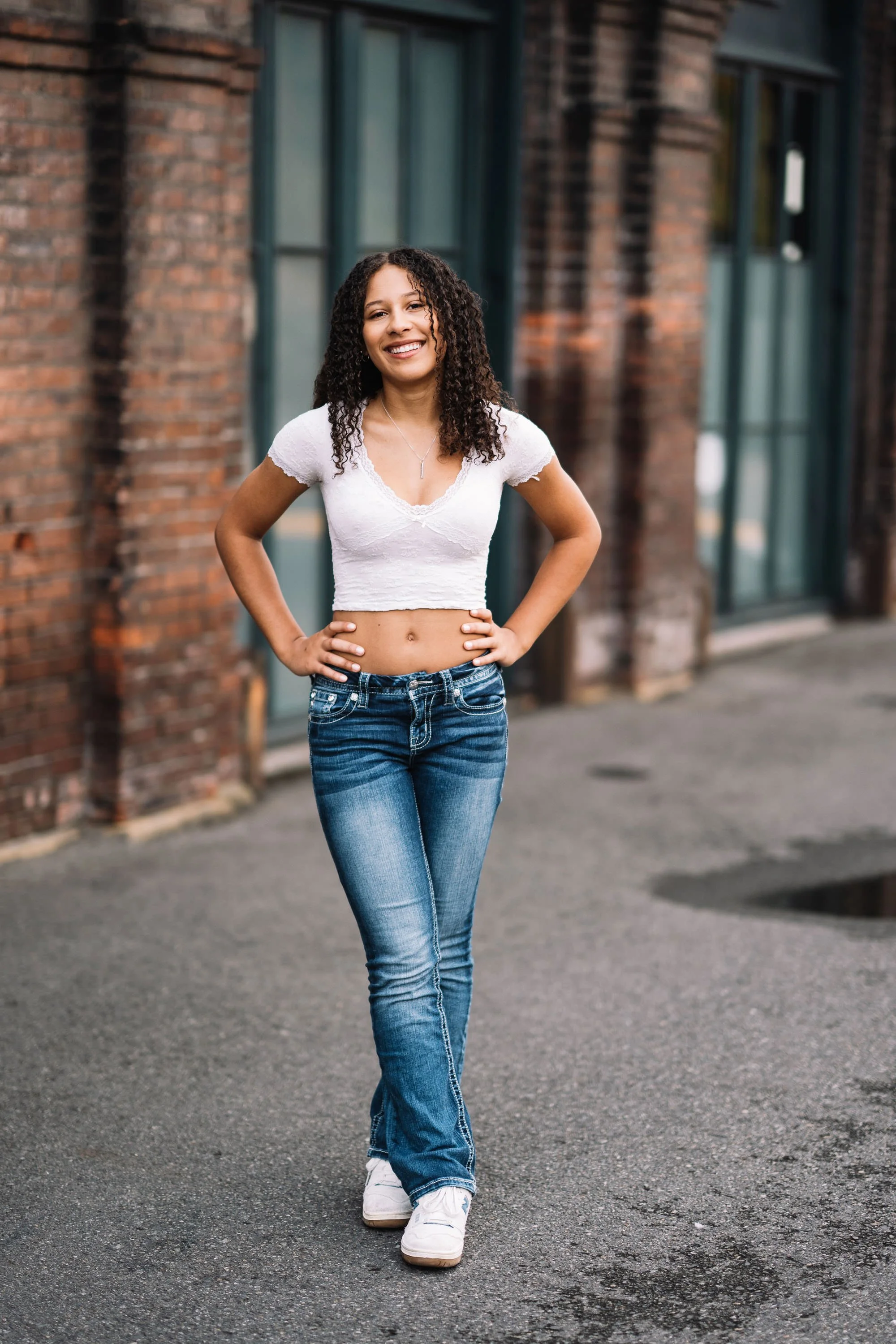 High school senior standing near railroad tracks in Georgetown Seattle