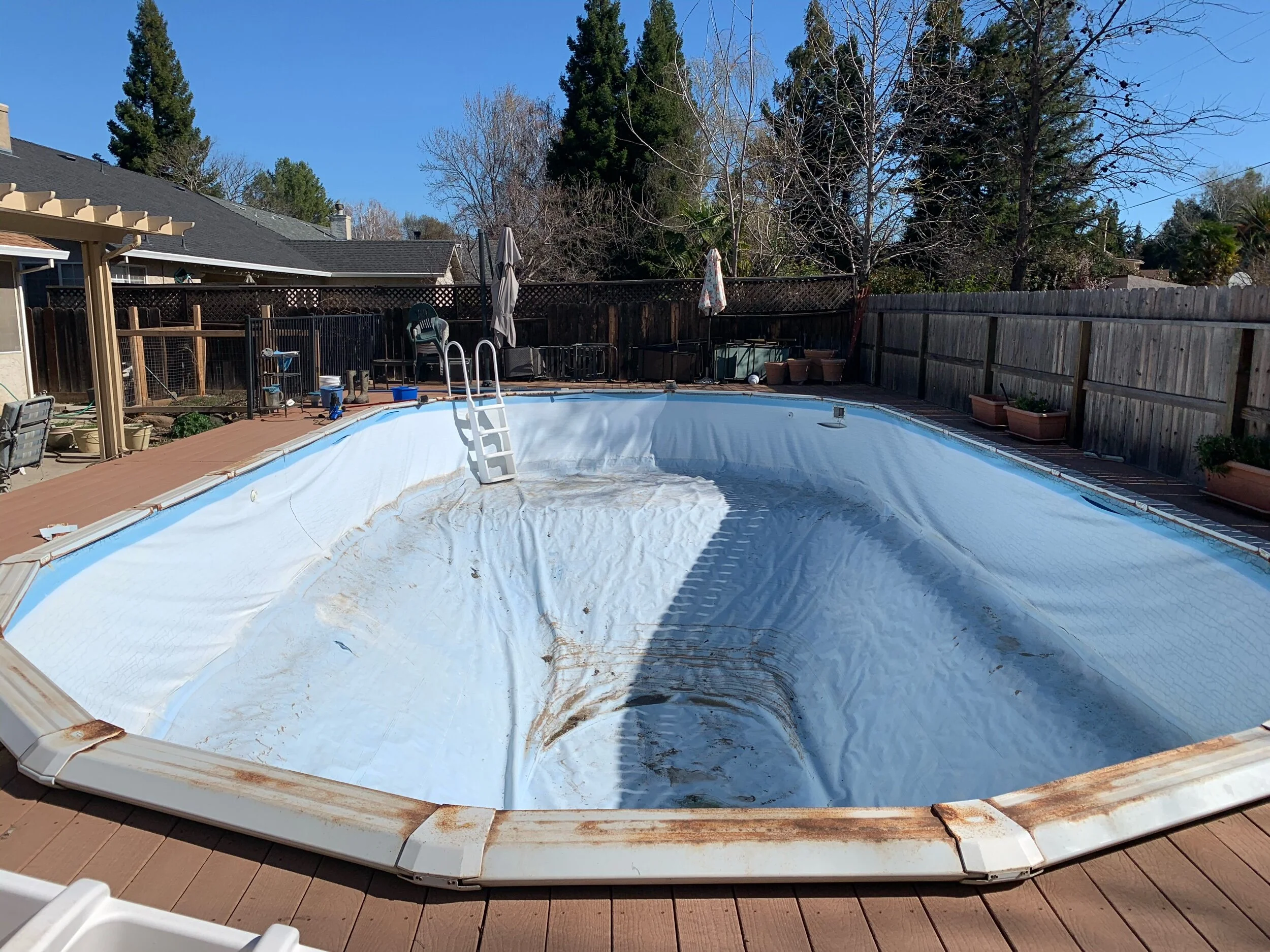Old liner is ready for replacement. Due to the deck being built so close to pool without any access, a custom liner was the only option.