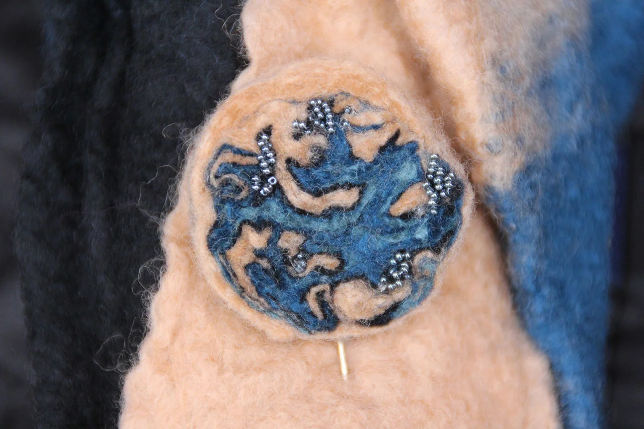Felt stick pin. Wet felted and bead appliquéd.