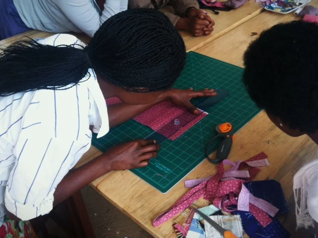 Josie using the ruler and rotary cutter for the first time.