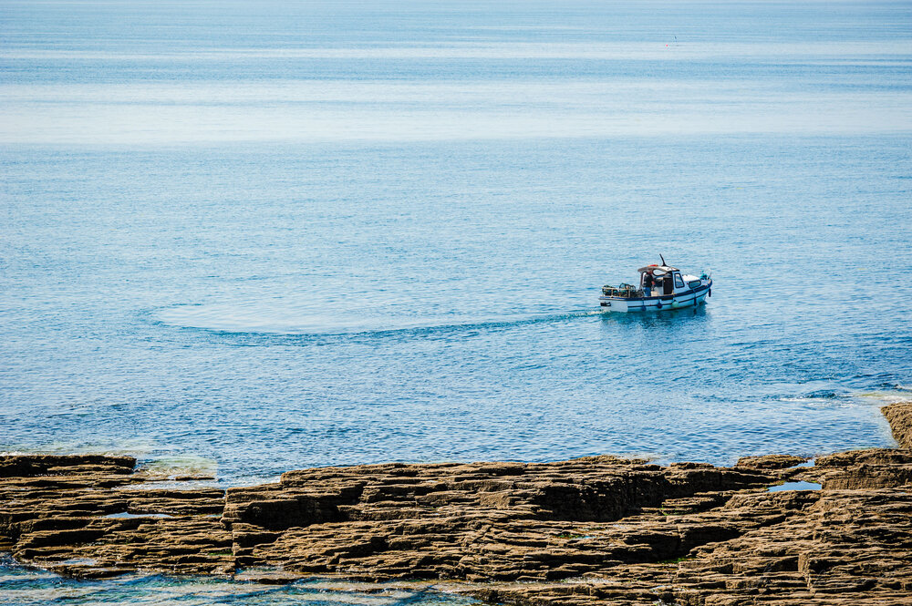  A Lobster Fisherman off the coast of Hook Head in the clear blue water