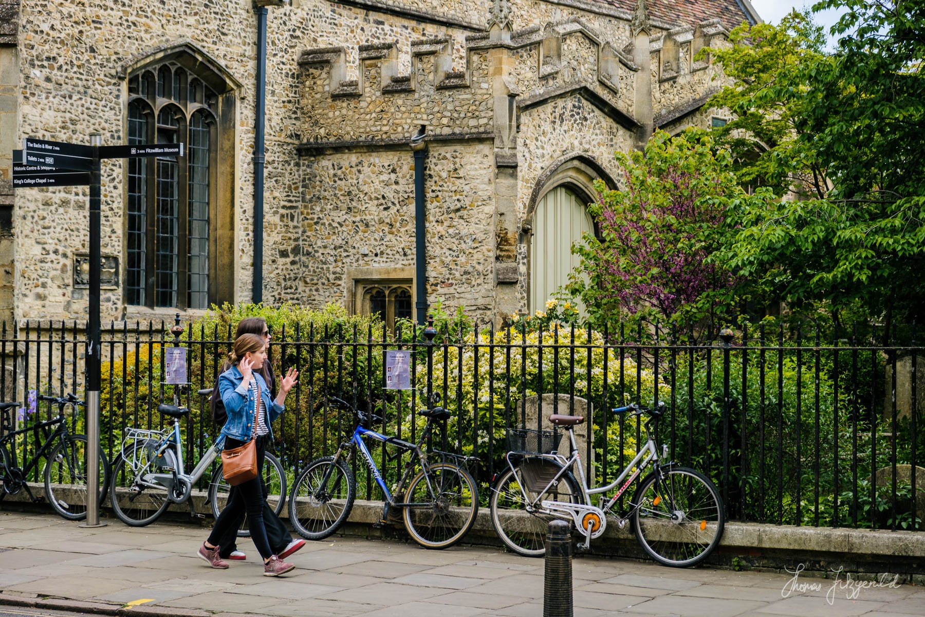 People walking by an old Church in Cambridge