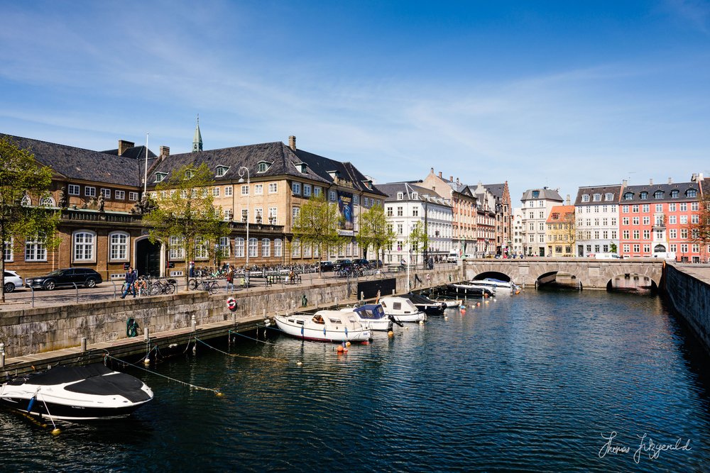 One of the canals with a jetty and parked boats in Copenhagen