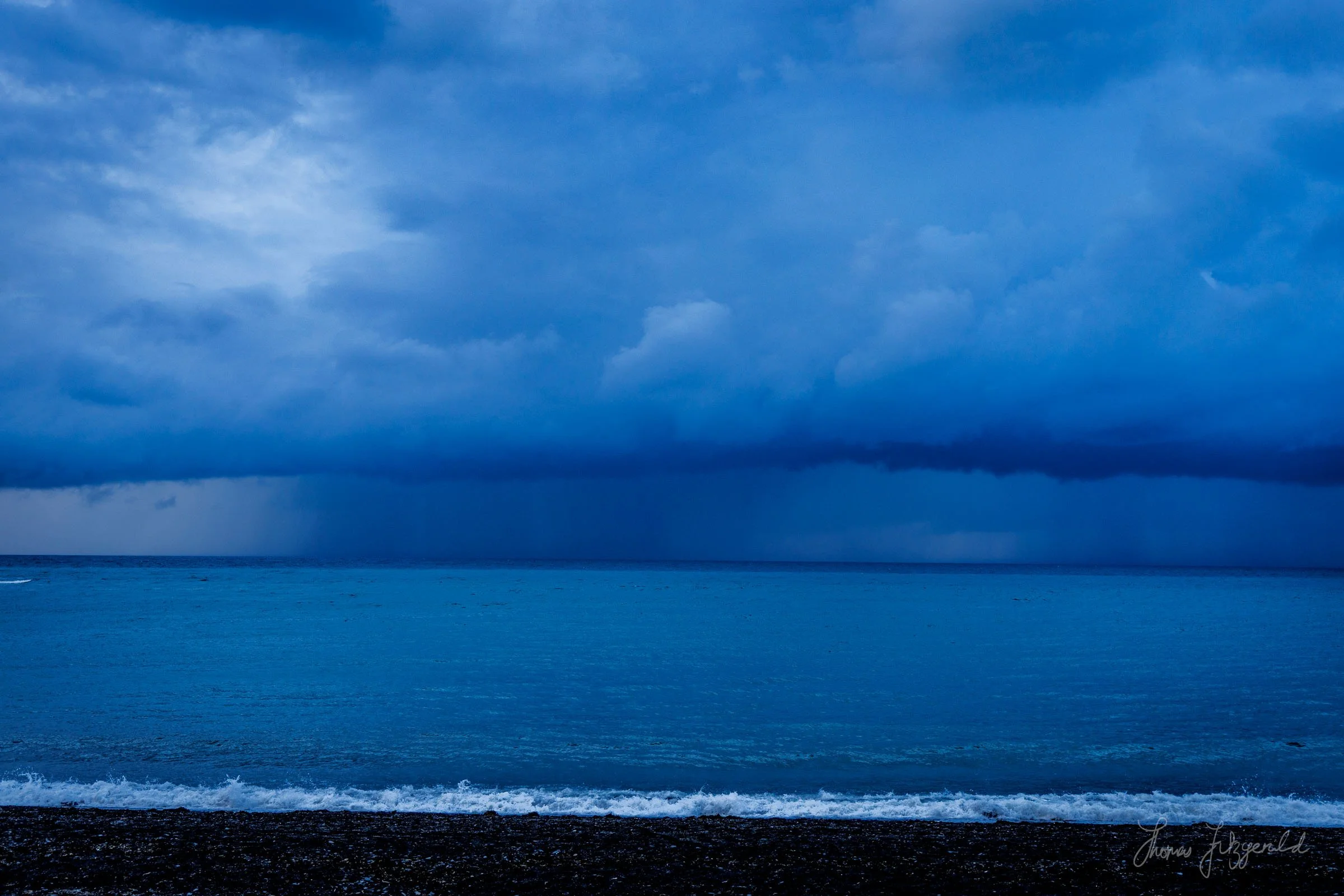 Shaowers rolling across the sea at Cardigan Bay, as seen from Aberystwyth seafront