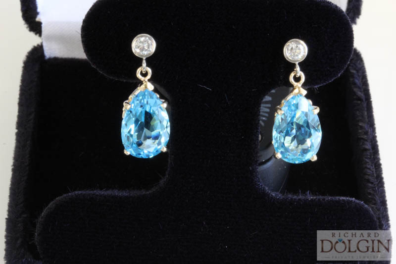 Blue topaz dangle earrings with bezel set round diamond