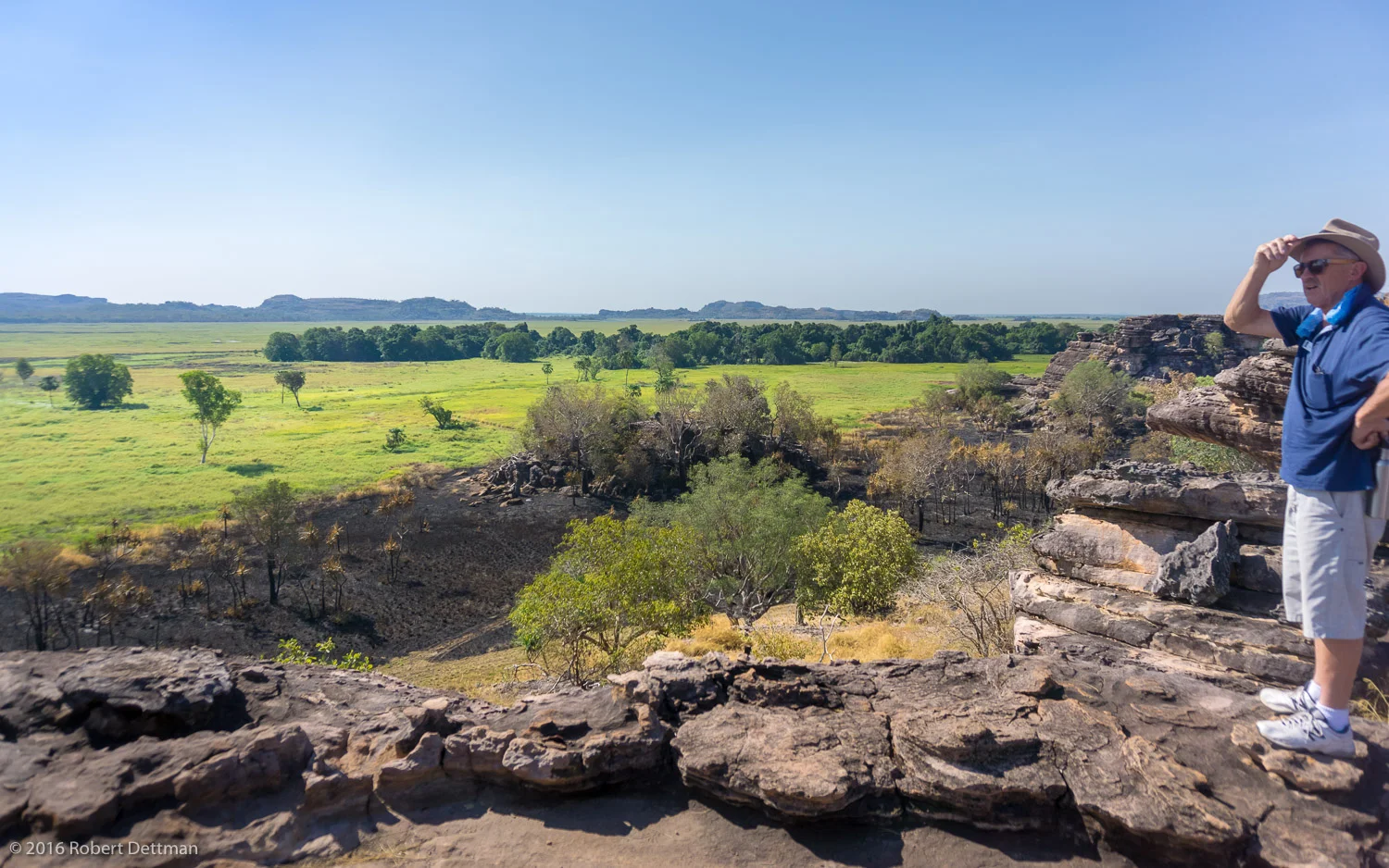 A "native" person surveys his domain from the edge of the rock shelter. The elevated location provides magnificent views over the flood plain to the west.