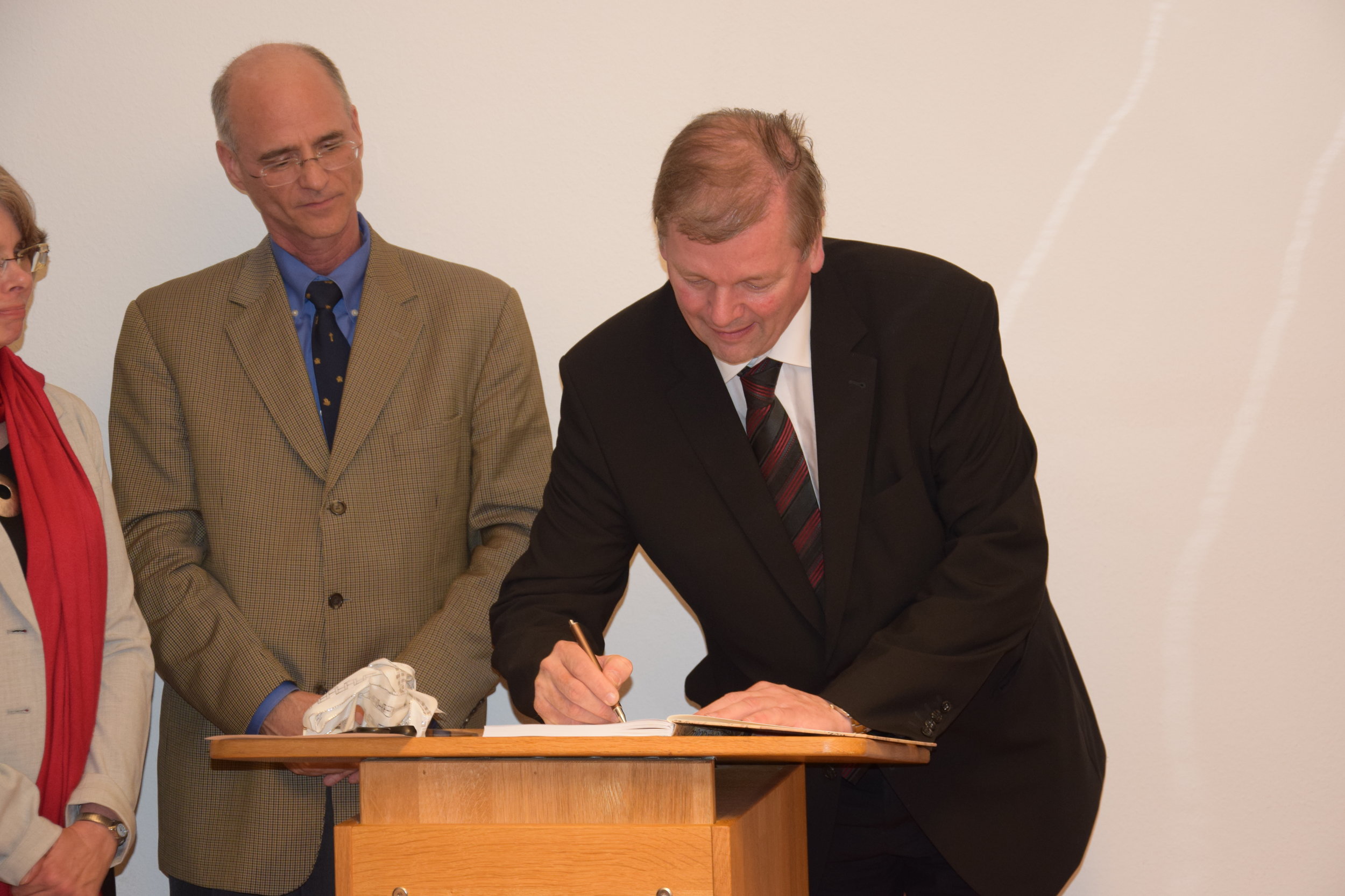 Prof. Kampmann signing the Guest Book.JPG