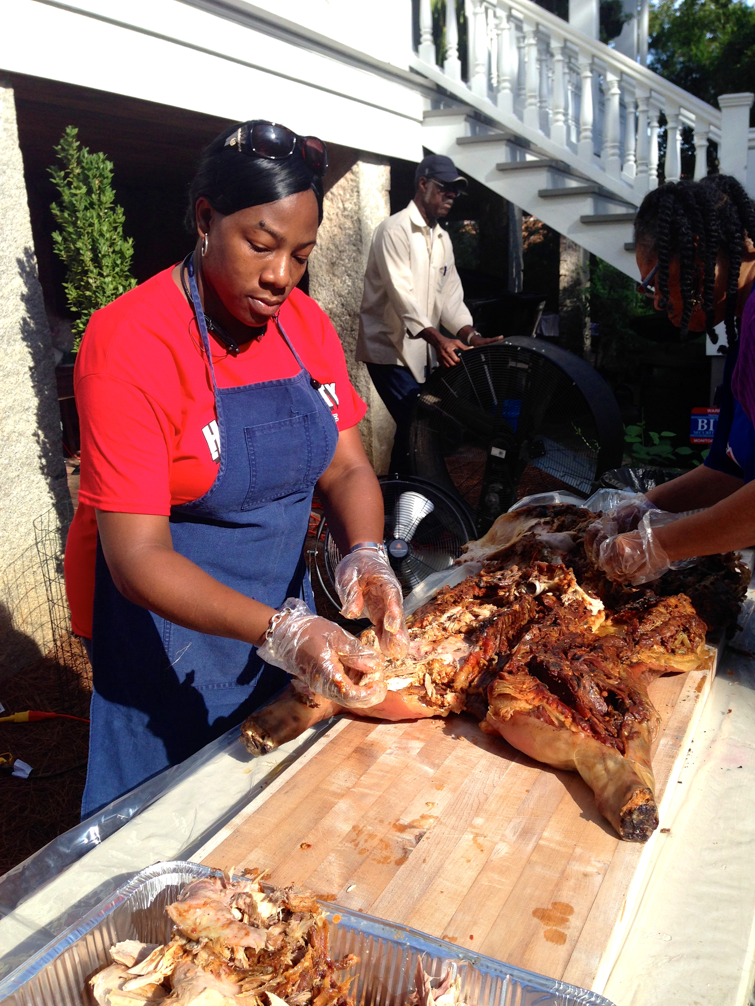 Barbeque! And working hard to pull it off the bones and chop it for serving.