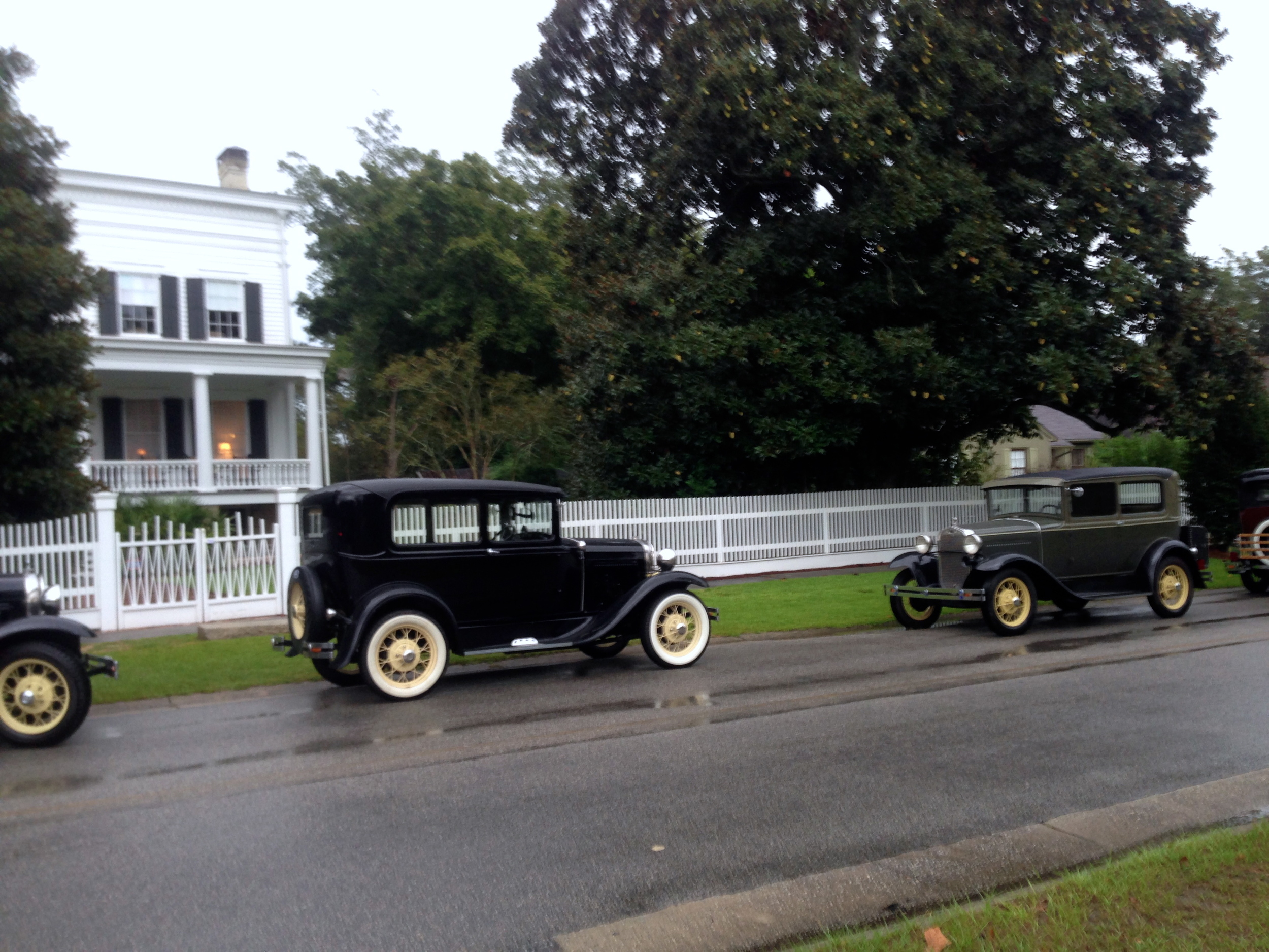 On a wet evening Elm Street becomes lined with the old cars.